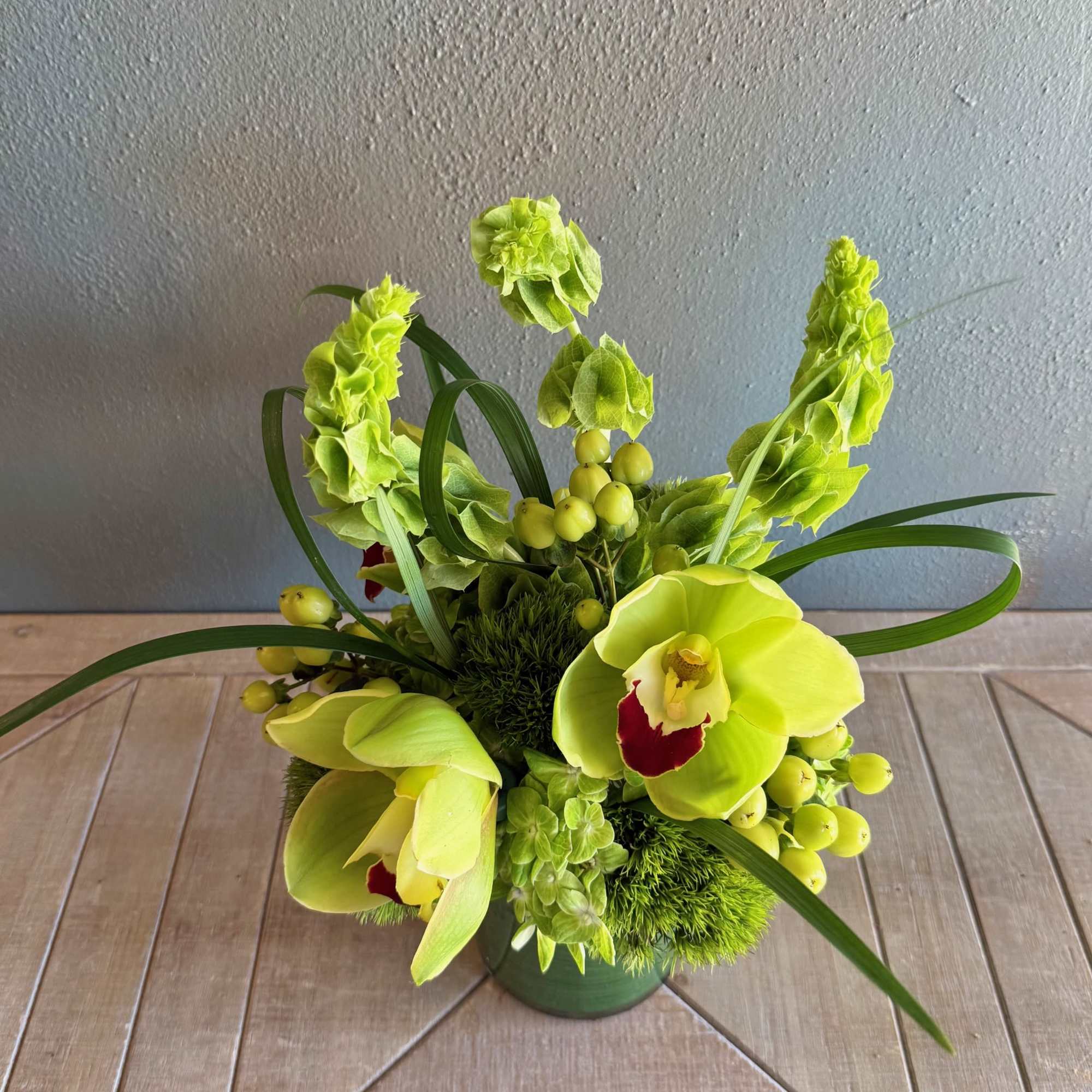 This whimsical arrangement features a beautiful mix of textural flowers in a