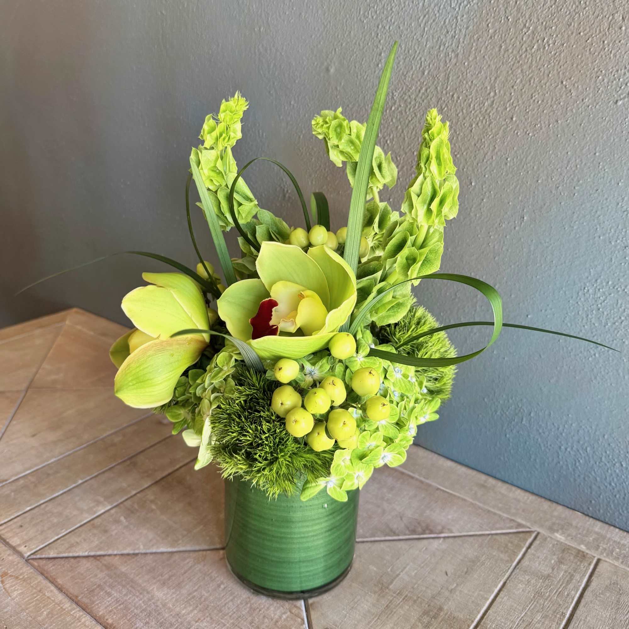 This whimsical arrangement features a beautiful mix of textural flowers in a