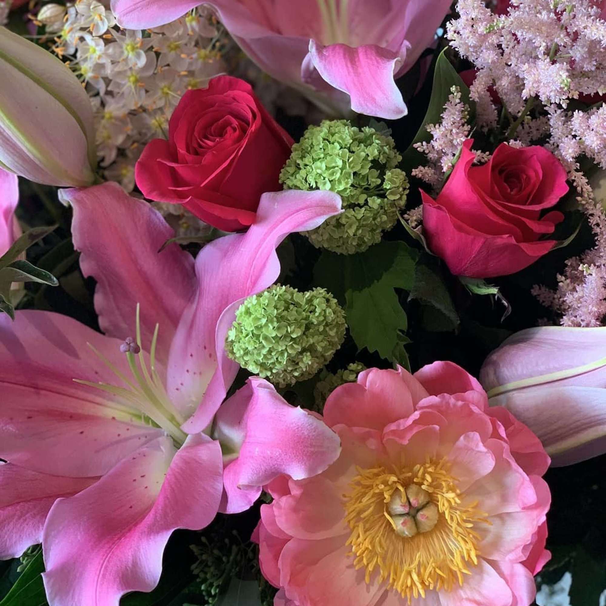 Elegant large pedestal vase filled with magnificent oriental pink lilies, hot pink