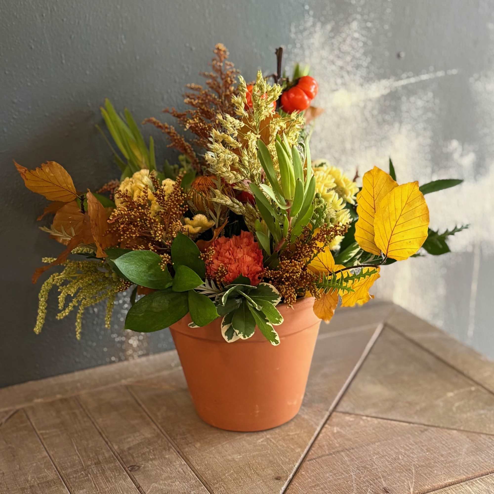 A warm, earthy arrangement, Terracotta, celebrates the beauty of autumn with vibrant A warm, earthy arrangement, Terracotta, celebrates the beauty of autumn with vibrant