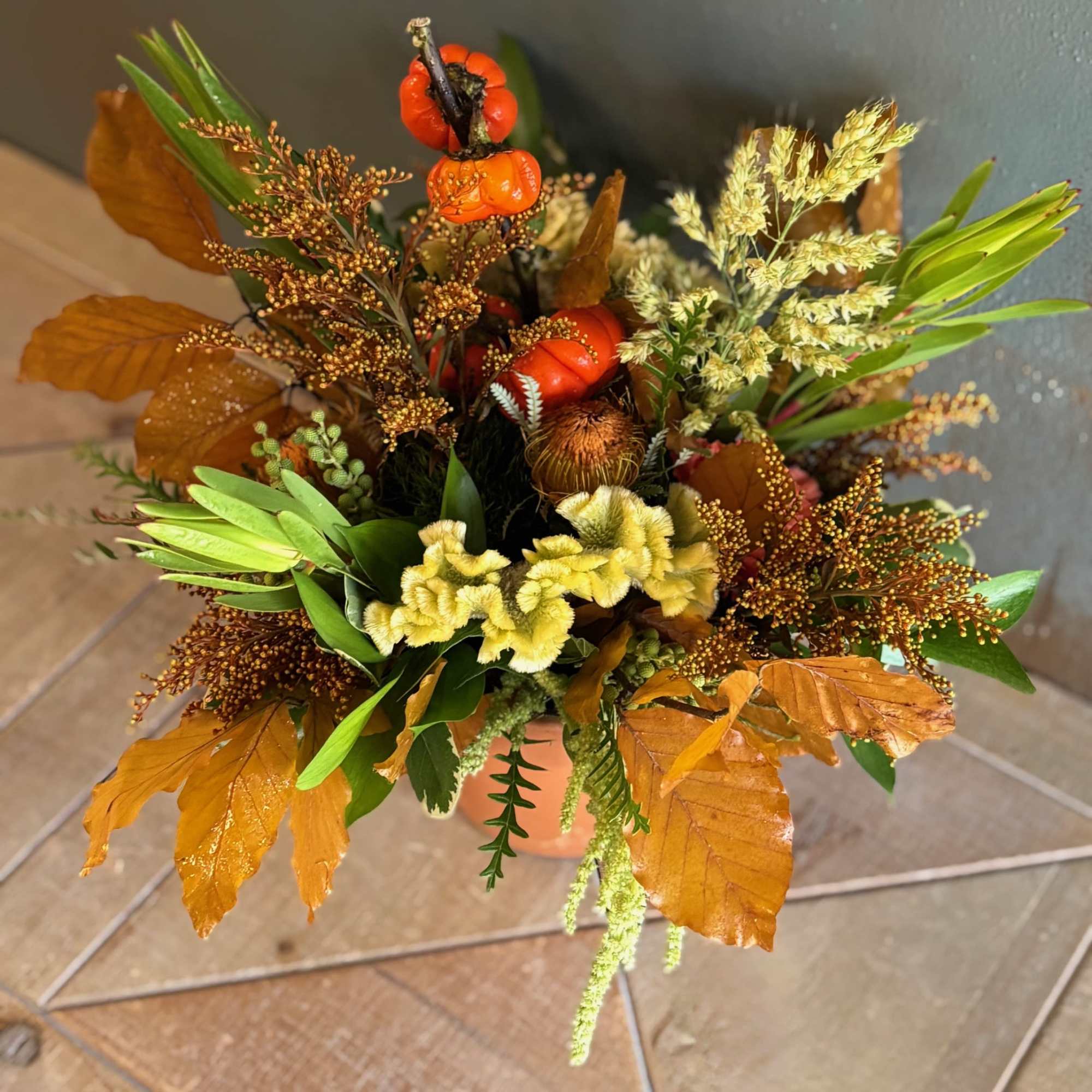 A warm, earthy arrangement, Terracotta, celebrates the beauty of autumn with vibrant A warm, earthy arrangement, Terracotta, celebrates the beauty of autumn with vibrant