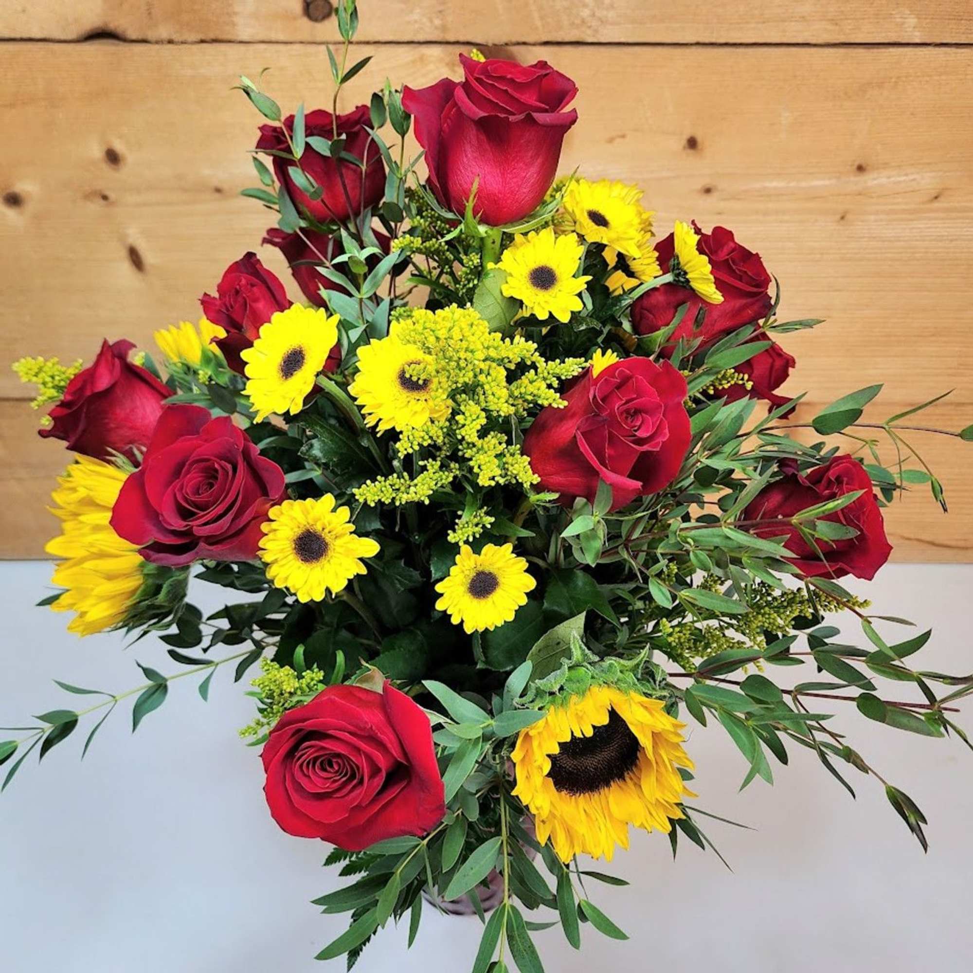 Bright and bold, this bouquet blends the warmth of summer with the Bright and bold, this bouquet blends the warmth of summer with the