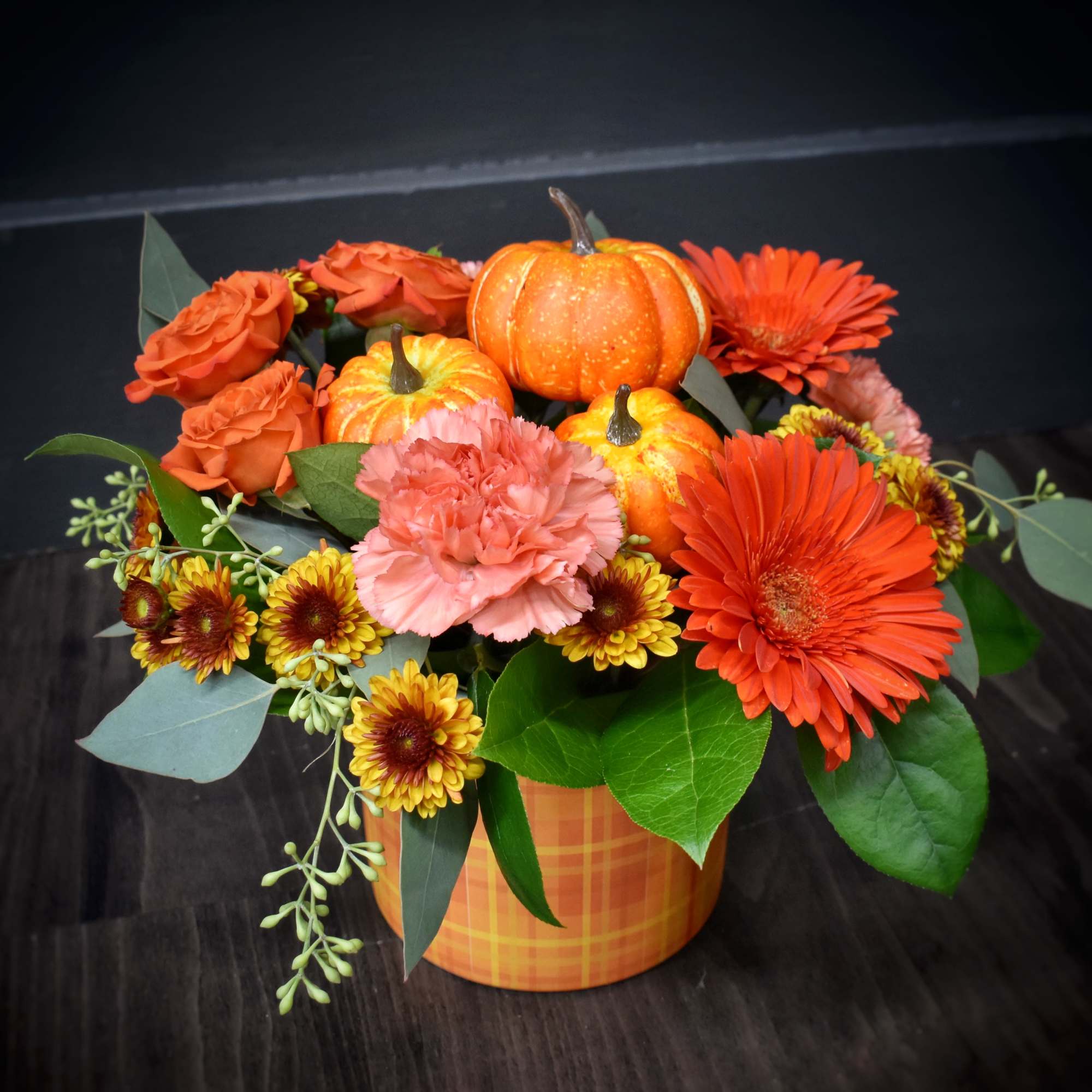 A warm gathering of gerbera daisies, mums, spray roses, carnations and a A warm gathering of gerbera daisies, mums, spray roses, carnations and a