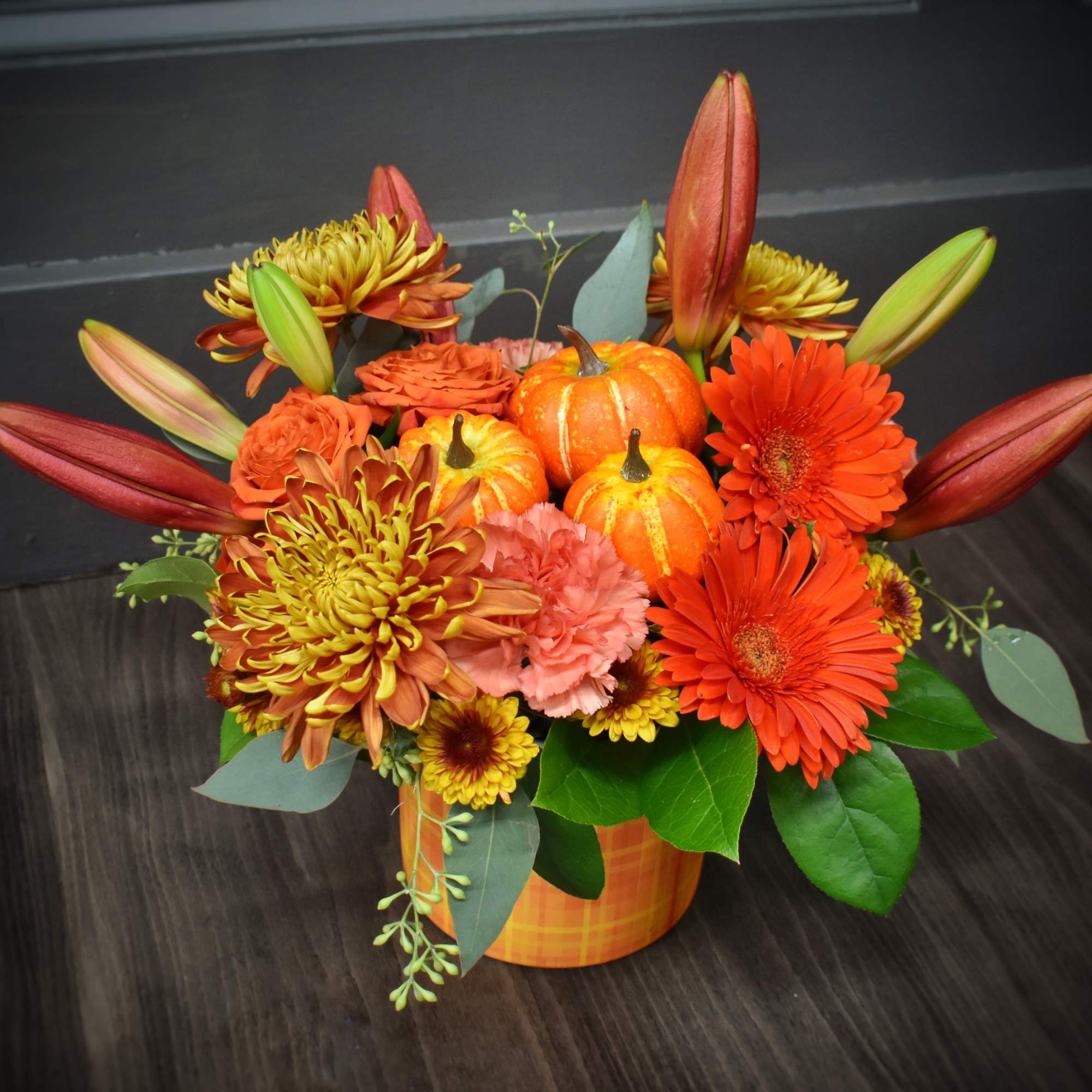 A warm gathering of gerbera daisies, mums, spray roses, carnations and a A warm gathering of gerbera daisies, mums, spray roses, carnations and a