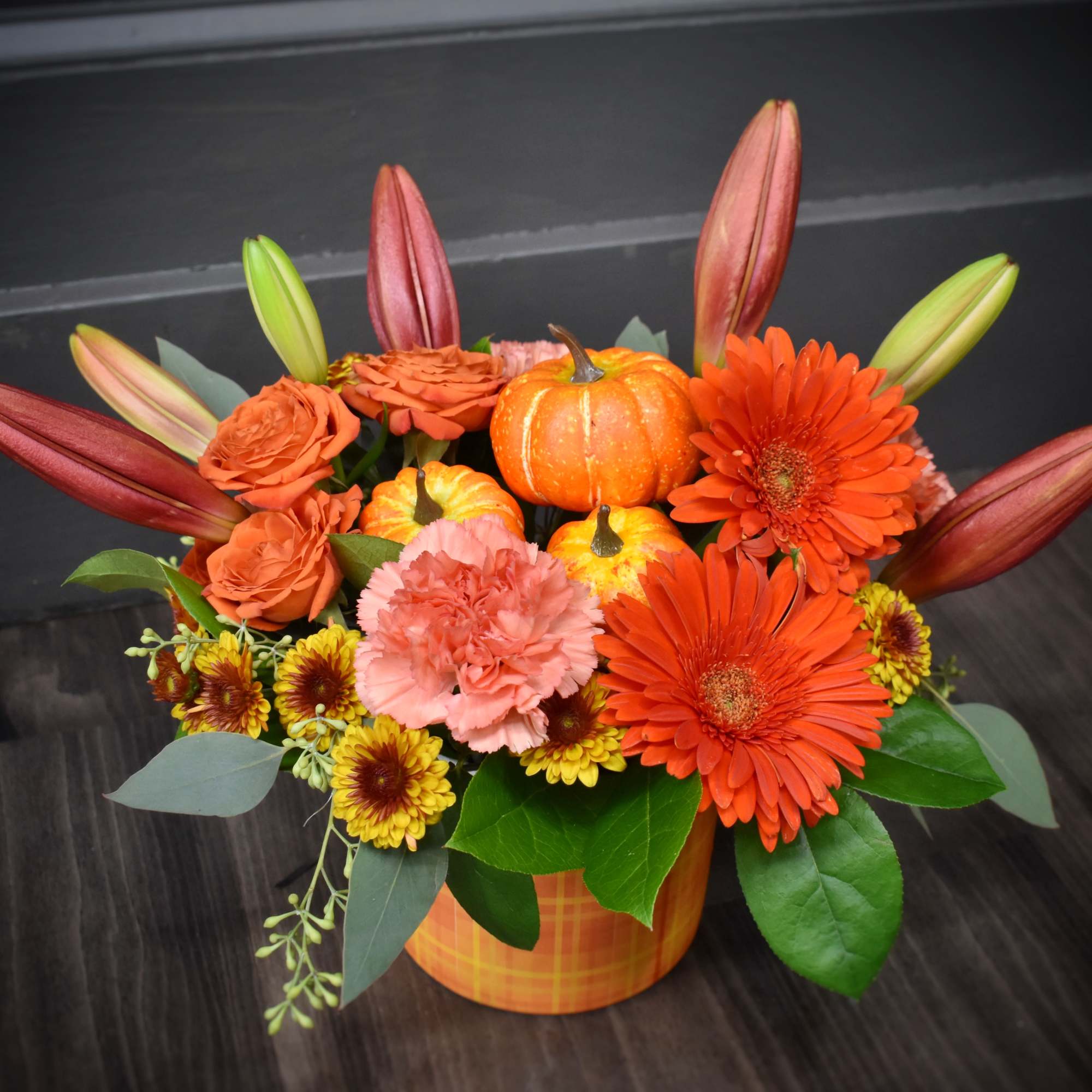 A warm gathering of gerbera daisies, mums, spray roses, carnations and a A warm gathering of gerbera daisies, mums, spray roses, carnations and a