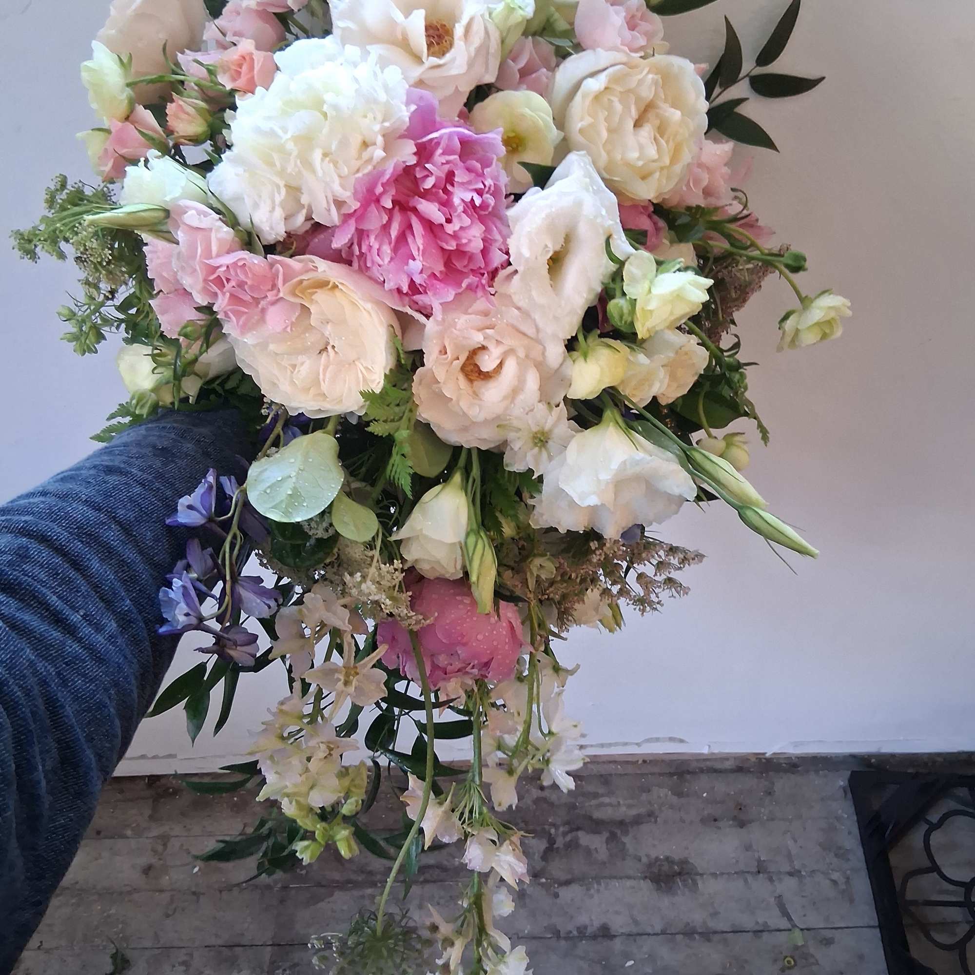 Beautiful vintage bridal cascade with peonies, butterfly ranunculus, roses and other fillers