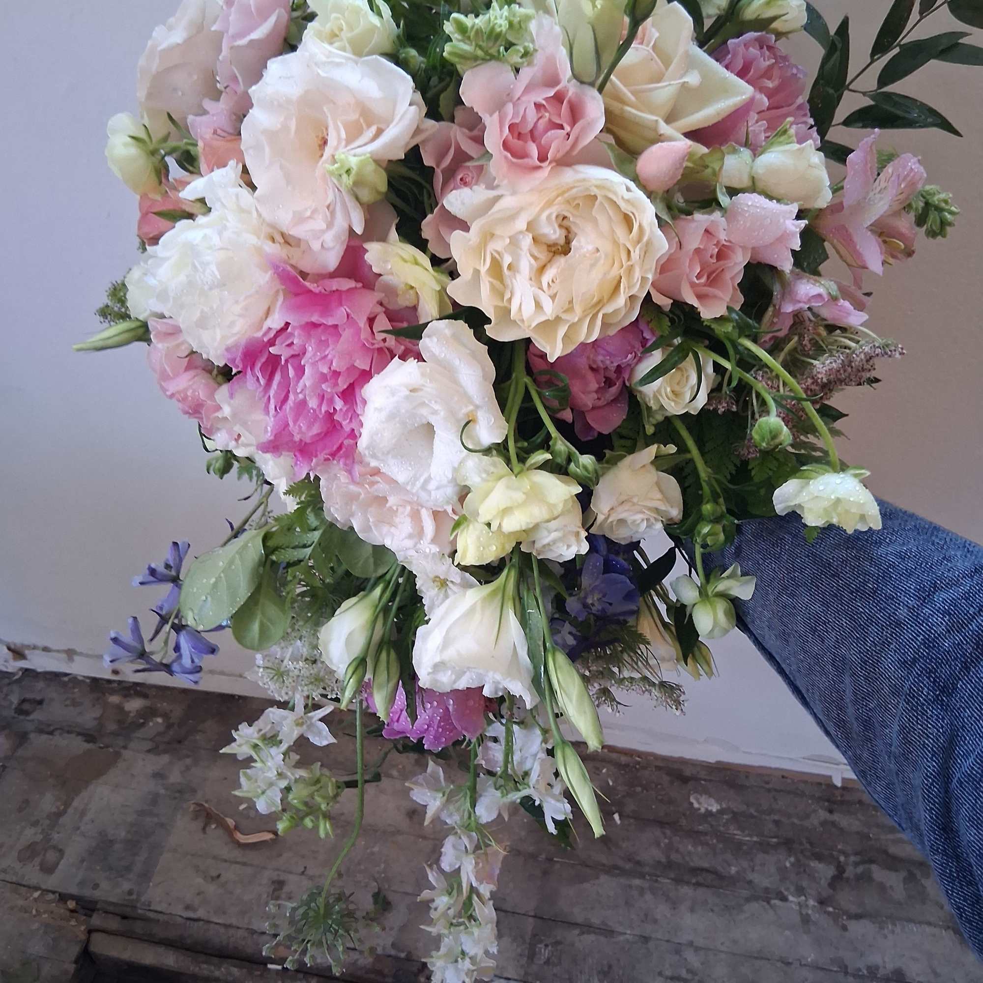 Beautiful vintage bridal cascade with peonies, butterfly ranunculus, roses and other fillers