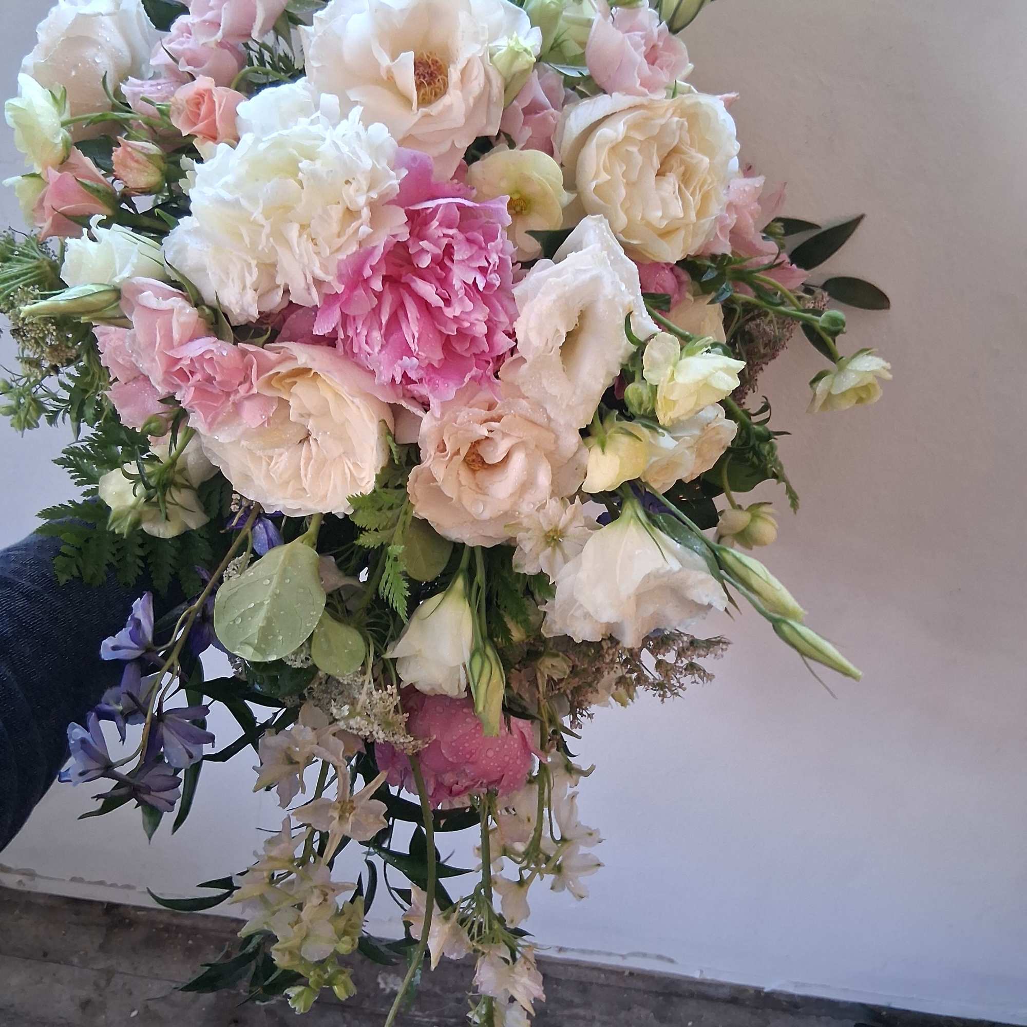 Beautiful vintage bridal cascade with peonies, butterfly ranunculus, roses and other fillers