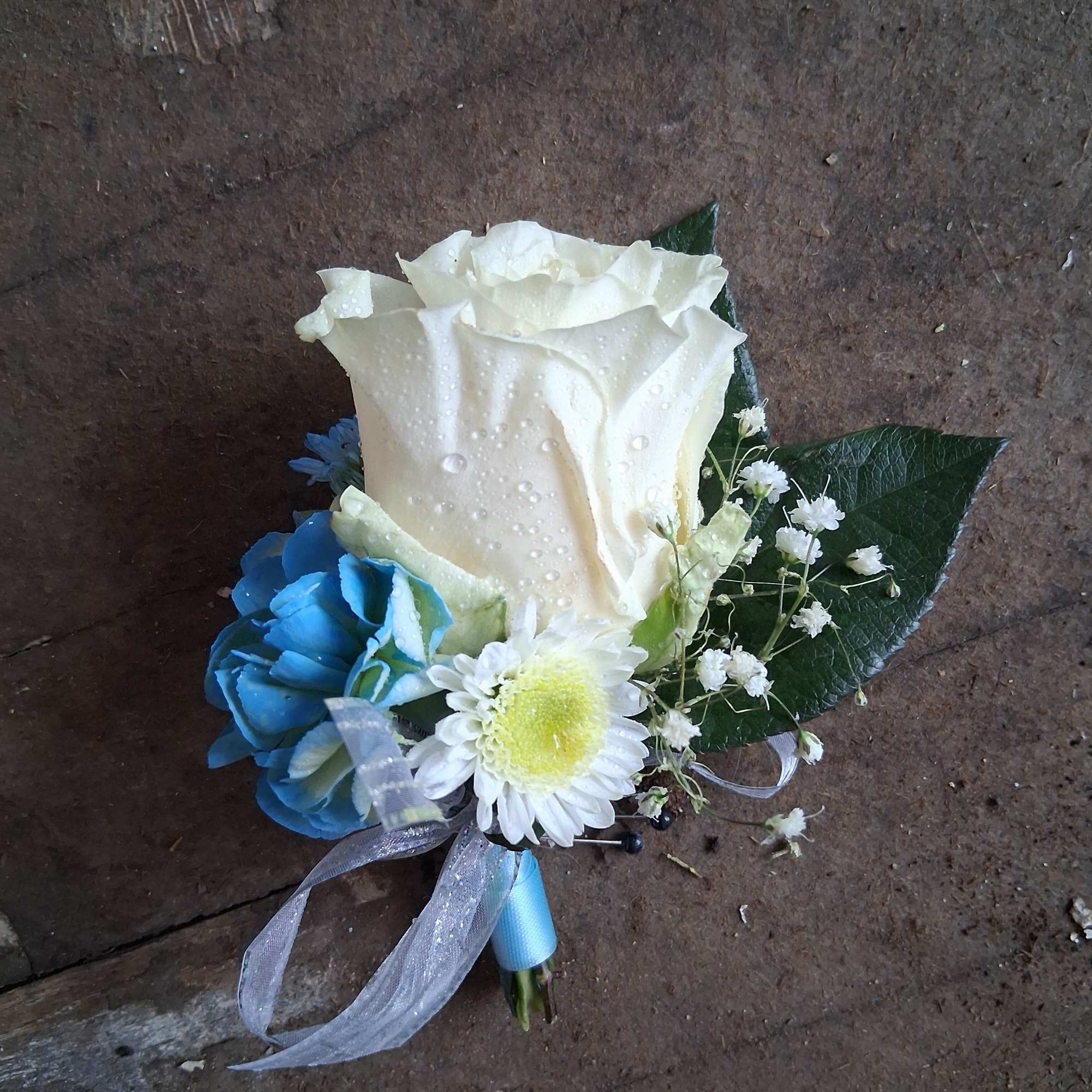 Beautiful white rose and blue tinted spray carnation with baby&#039;s breath and