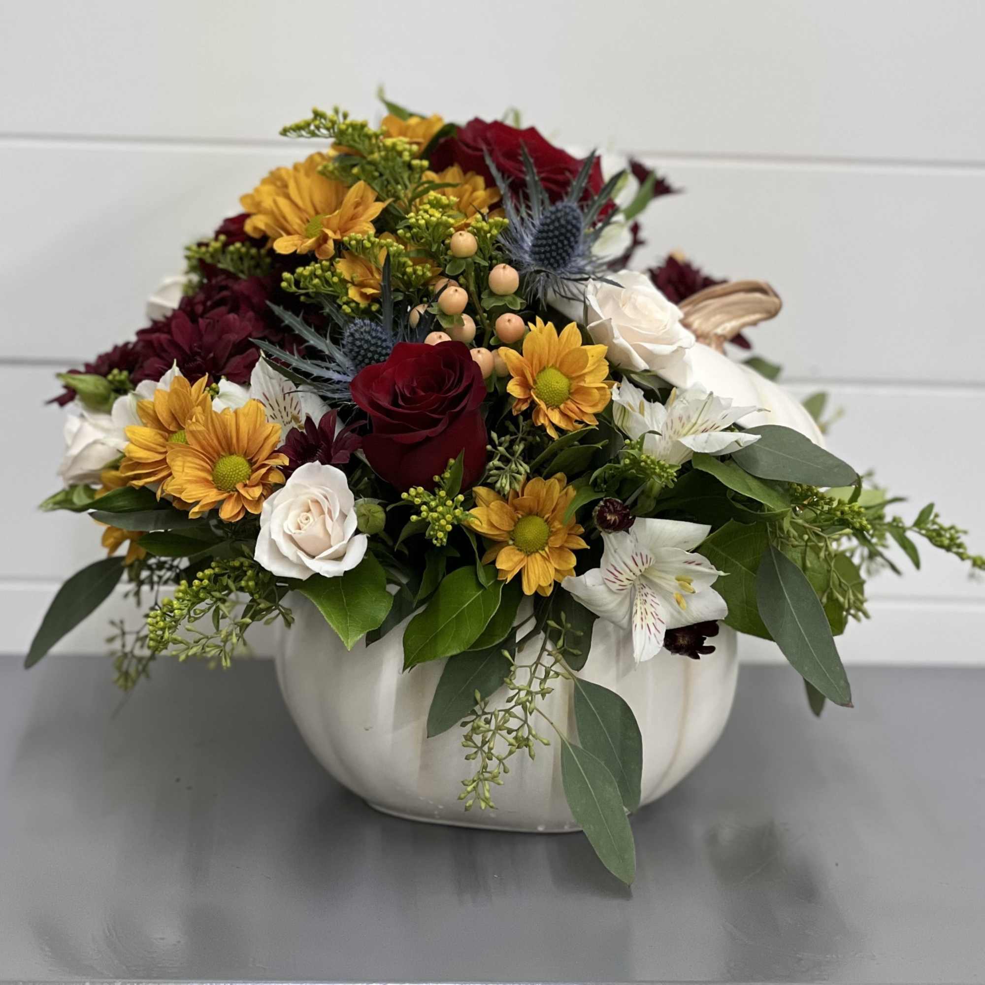 Bright fall colors really pop inside this beautiful white ceramic pumpkin, perfect
