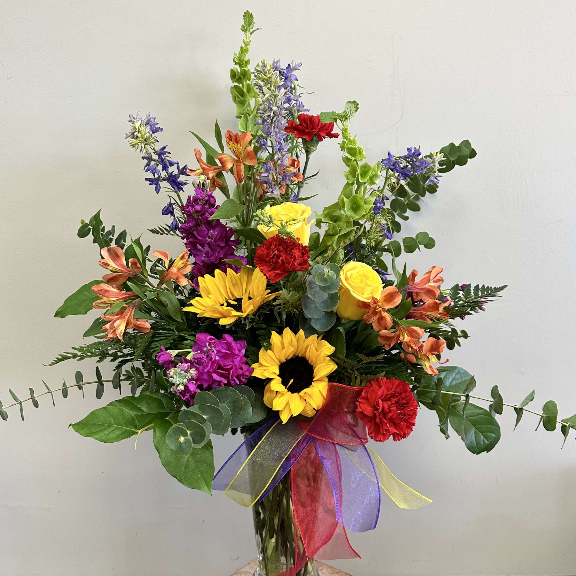 The perfect bright floral arrangement filled with sunflowers, stock, larkspur, alstroemeria and The perfect bright floral arrangement filled with sunflowers, stock, larkspur, alstroemeria and