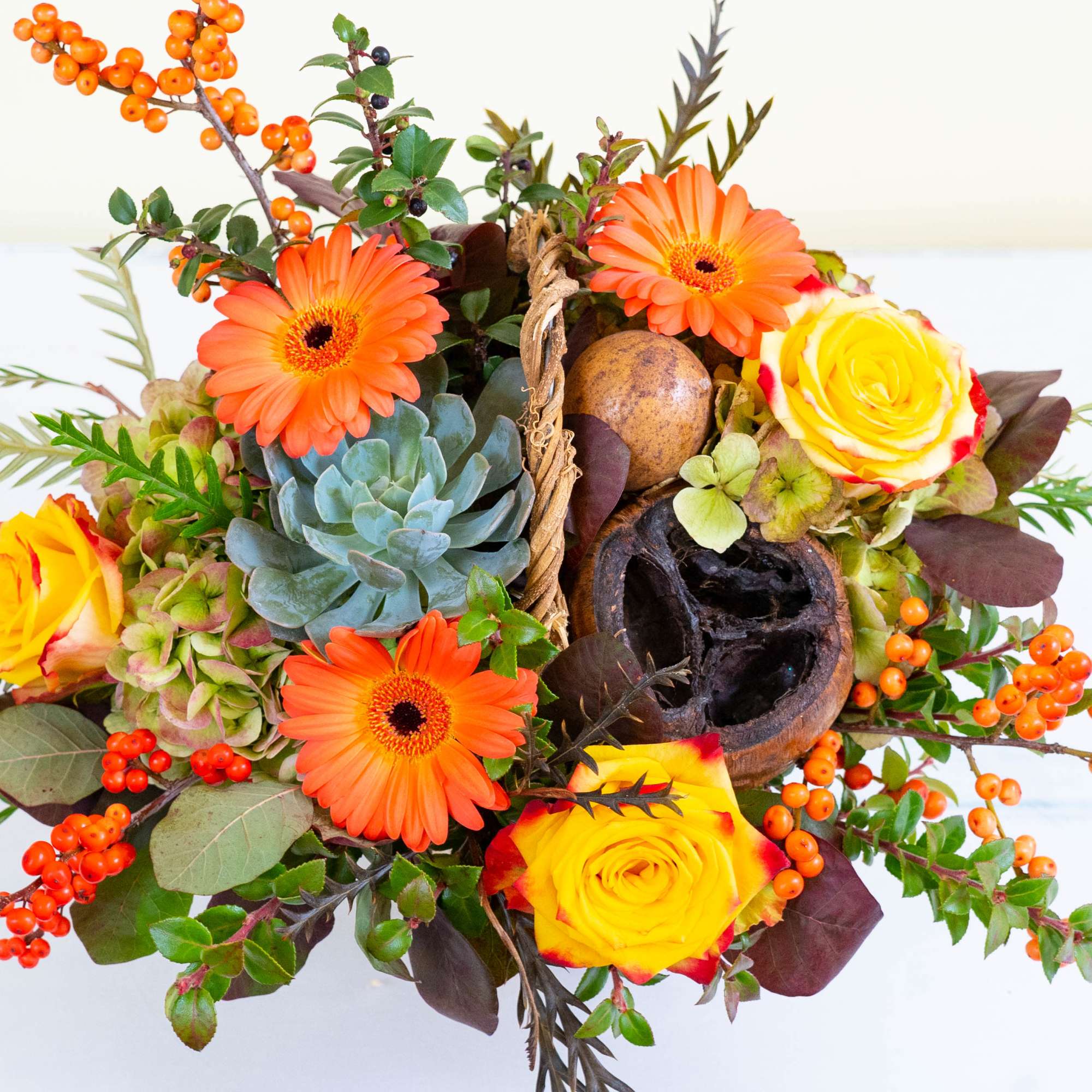 In a white birch container, Autumn Bliss is a stunning, harvest-themed arrangement