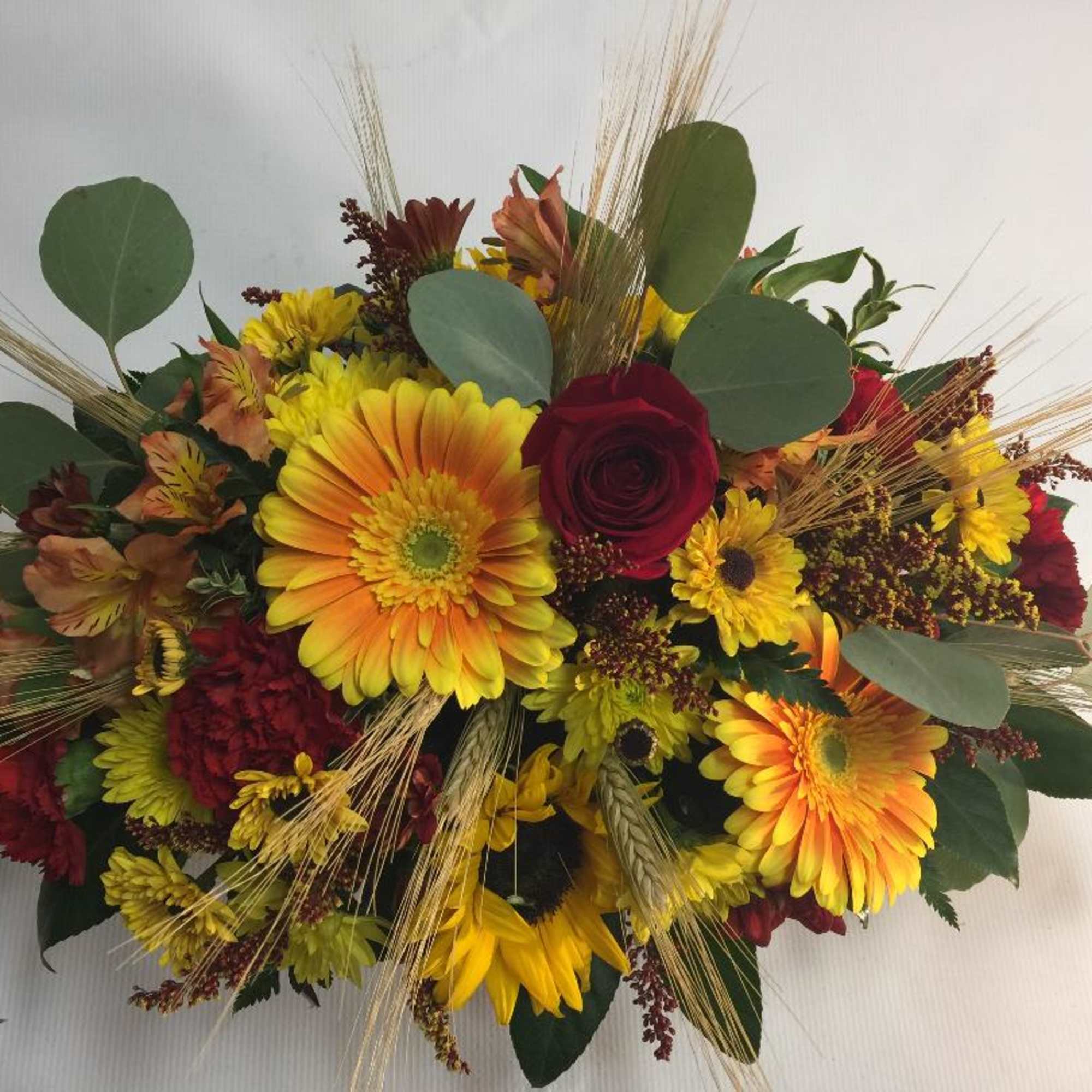 Our Autumn-inspired arrangement captures fall&rsquo;s unique, vibrant beauty. it&rsquo;s loosely gathered for
