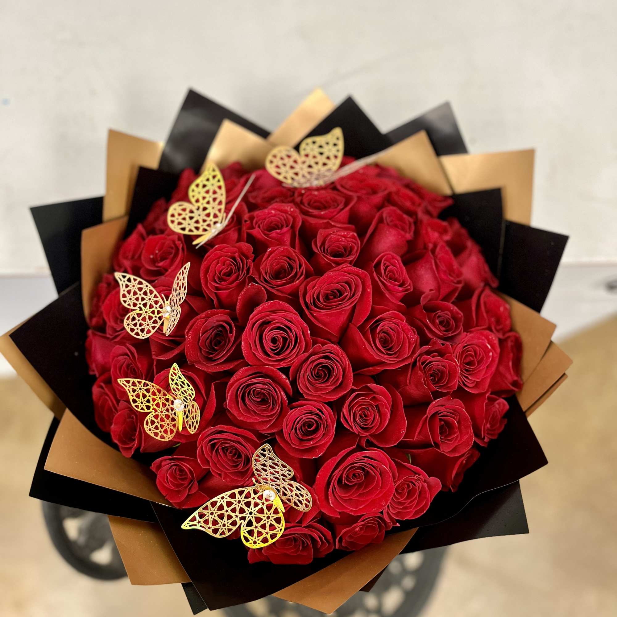 The Rose Bouquet includes 50 long-stem red roses. Wrapped in black paper