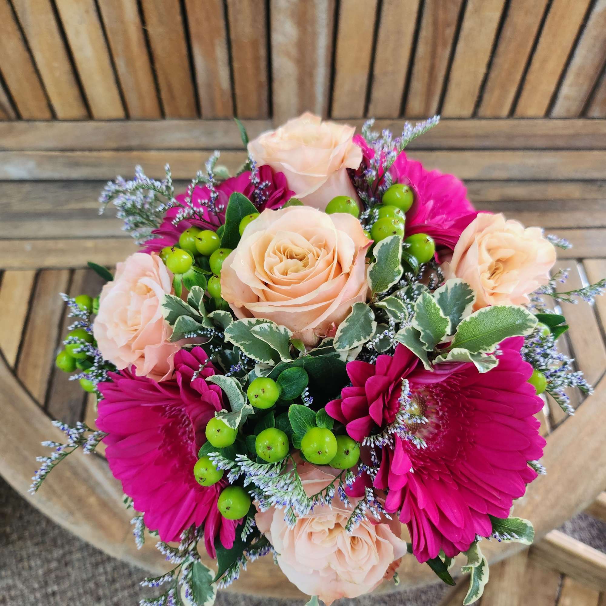 Hand tied bouquet of Gerber daisies and roses.