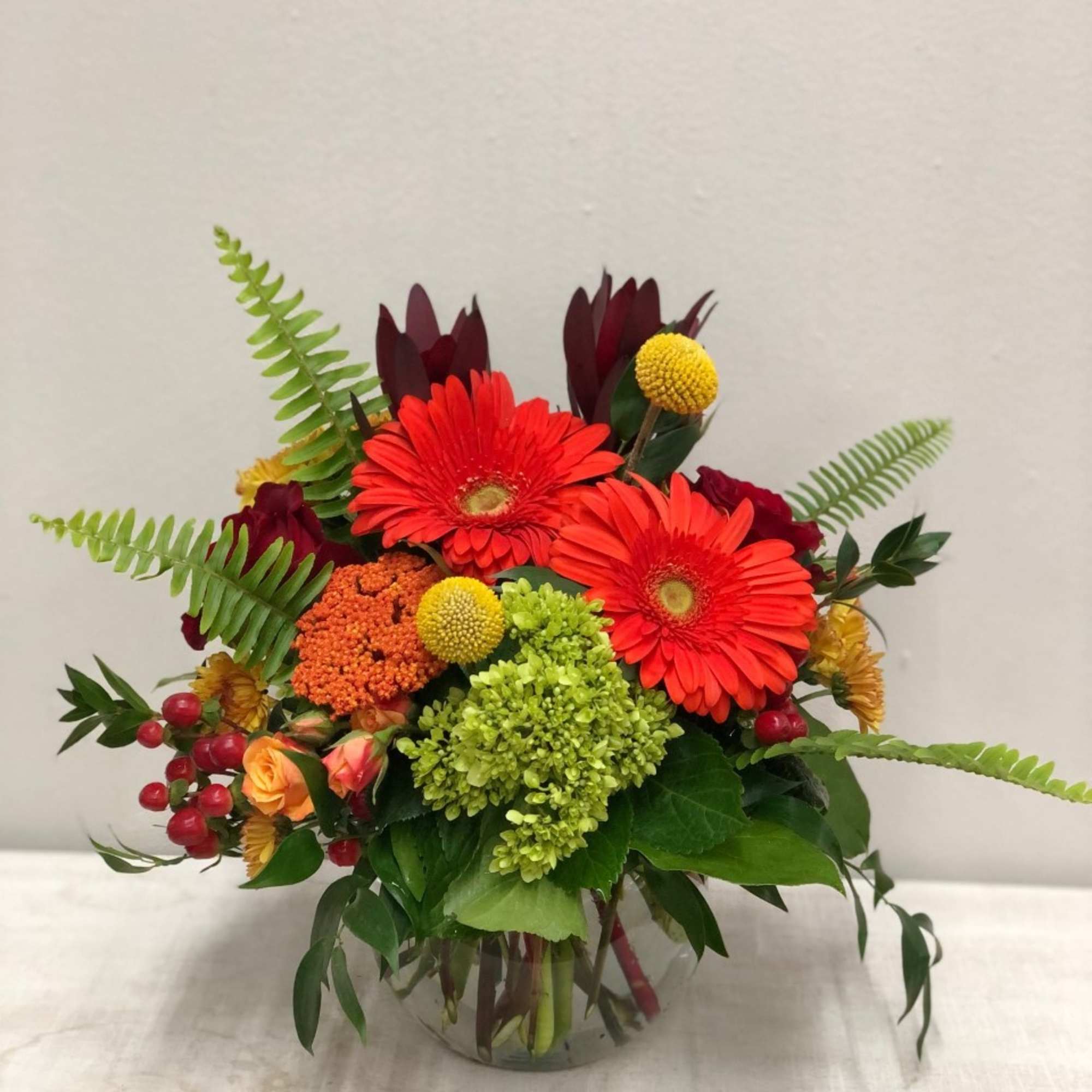 Lilies, gerbers, mini hydrangeas, fall buttons, spray roses, tulips, hypericum berries. 