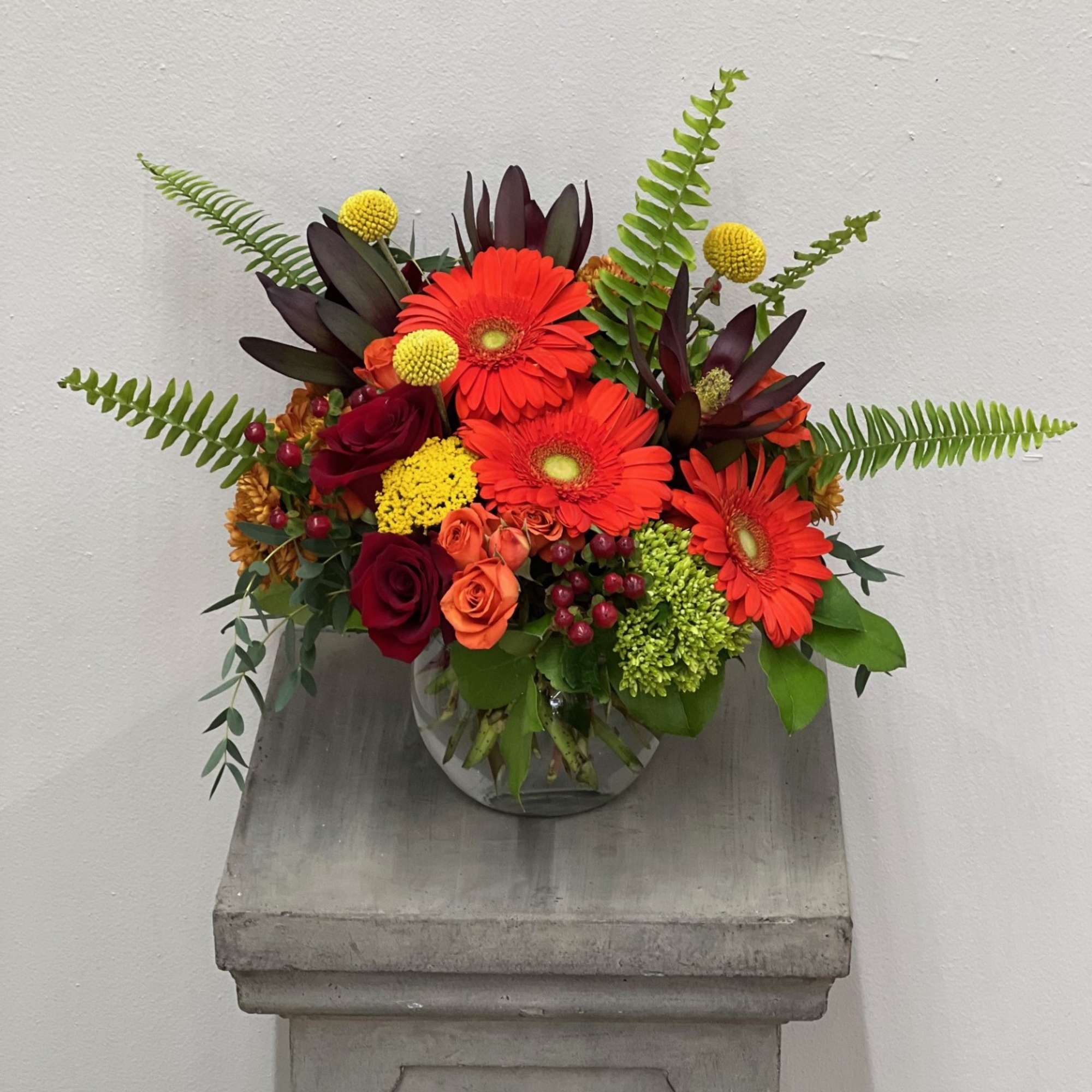 Lilies, gerbers, mini hydrangeas, fall buttons, spray roses, tulips, hypericum berries. 