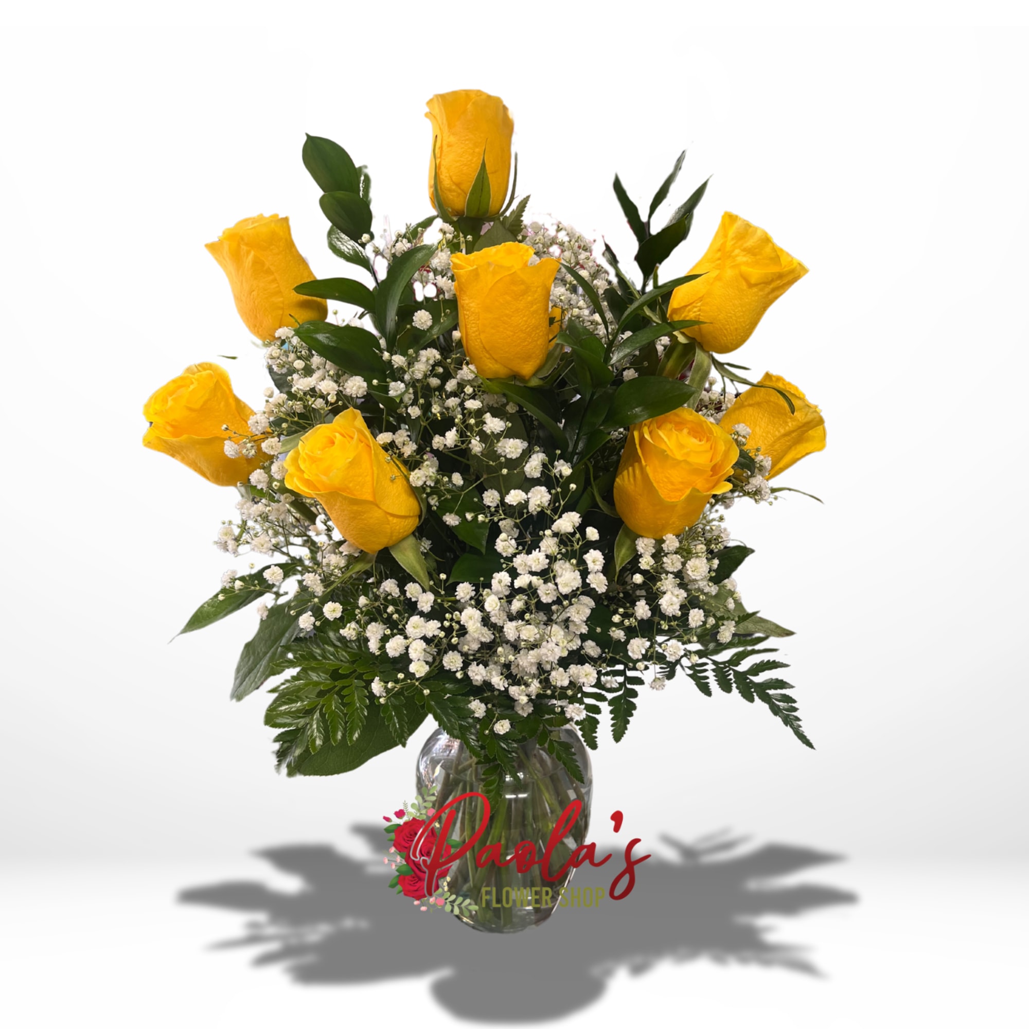 12 yellow roses with filler and greens in a rose vase