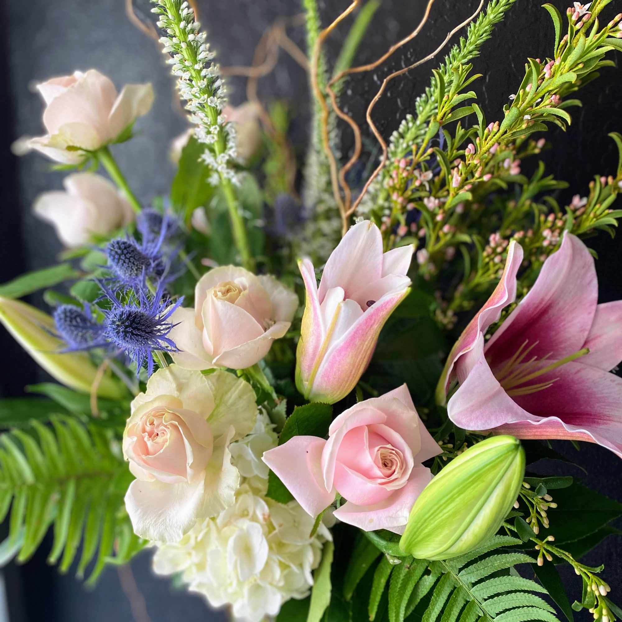 A fragrant arrangement with pink roses, lilles, and blues in a cluster-style A fragrant arrangement with pink roses, lilles, and blues in a cluster-style