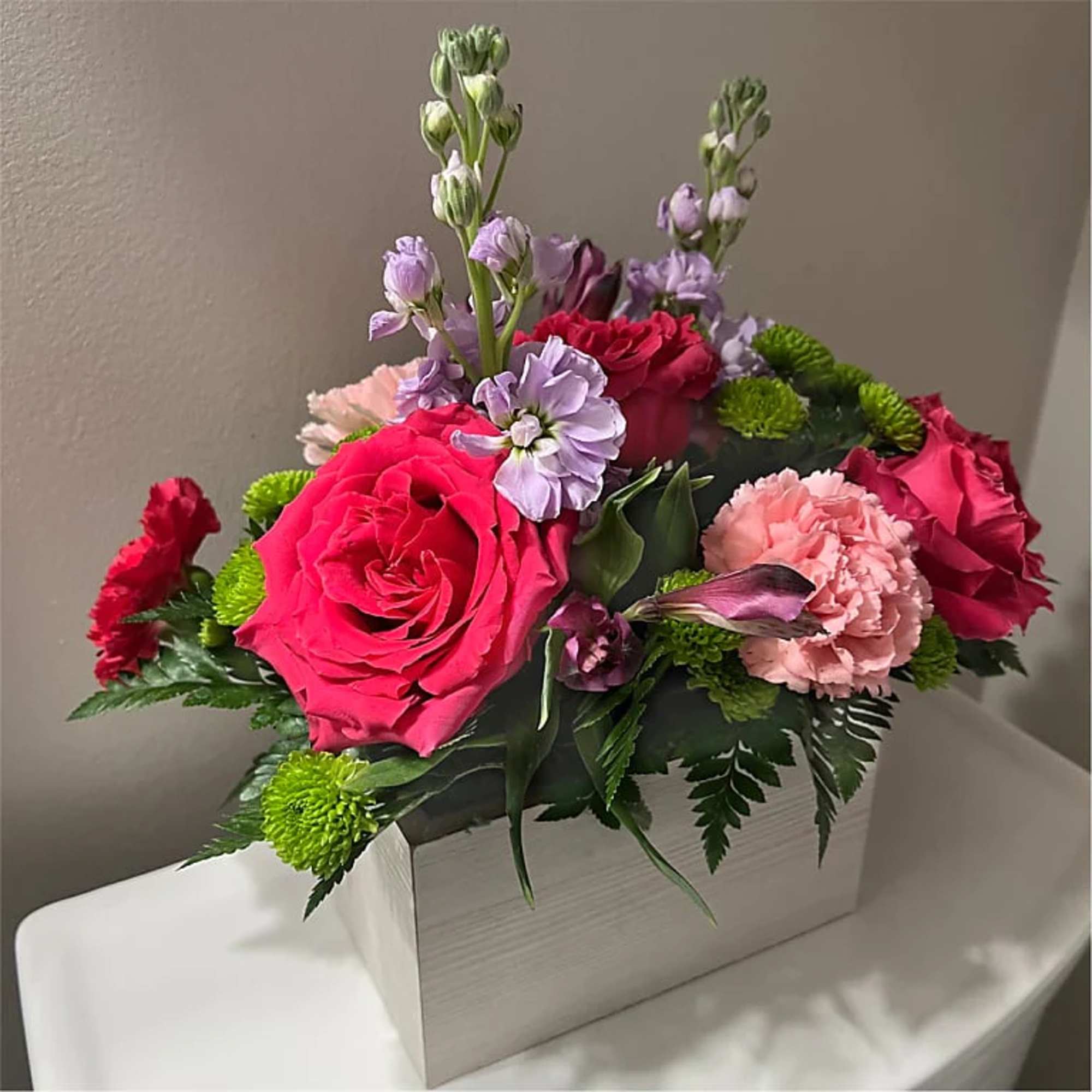 Fresh flower arrangement along fine foliage.
Bloom Details: Roses, Lily, Carnation, Mums, Hypericum