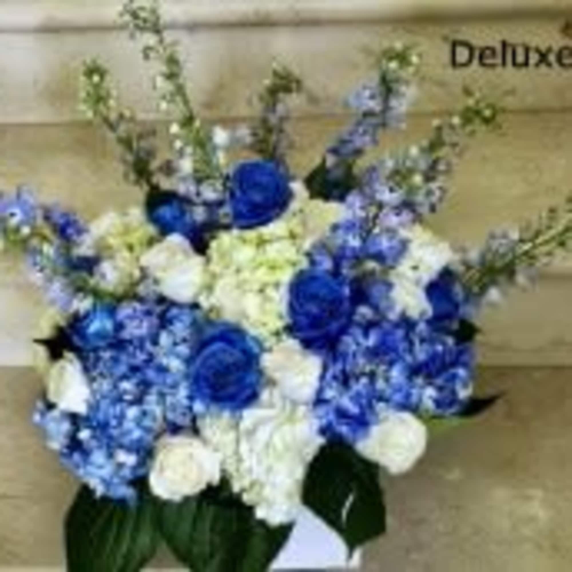 Featuring tall, elegant delphinium in shades of blue and lavender, paired with