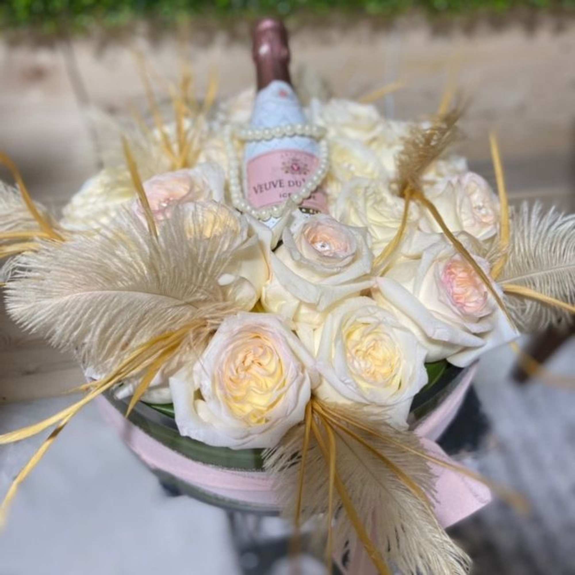 This arrangement includes roses, hydrangeas ,and other seasonal blooms. This is a