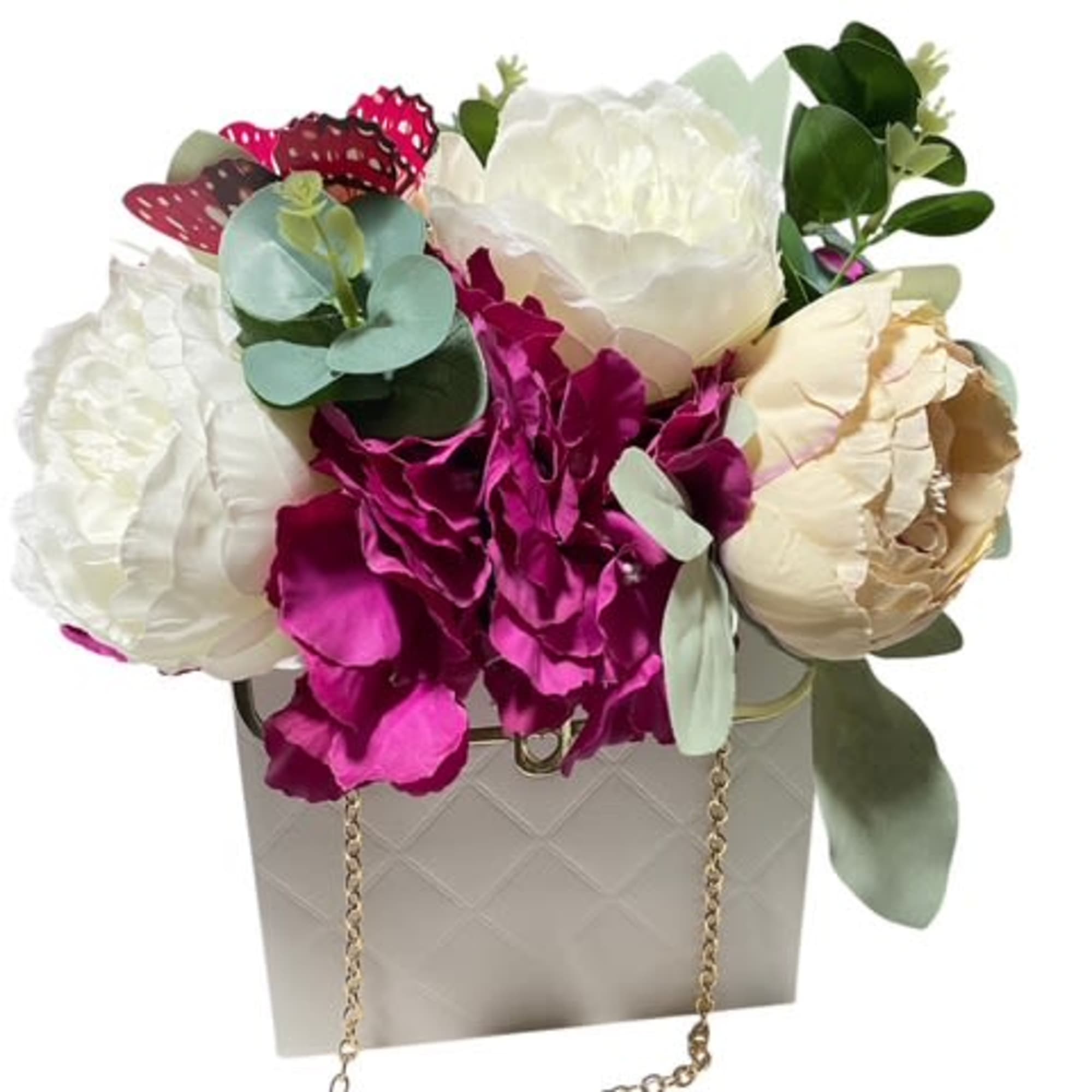 

Description: The &quot;Blooming Elegance Purse&quot; is a stunning silk flower arrangement delicately