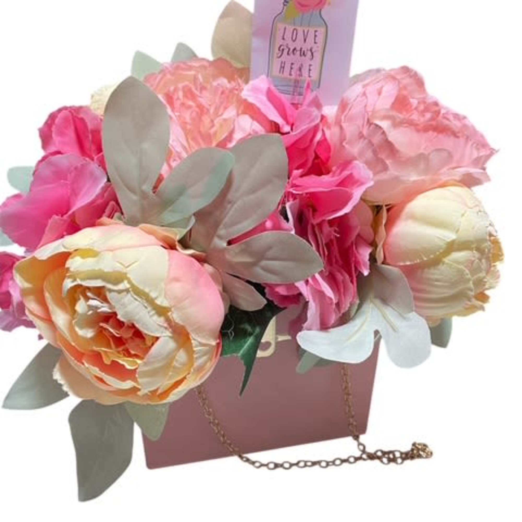 

Description: The &quot;Blooming Elegance Purse&quot; is a stunning silk flower arrangement delicately