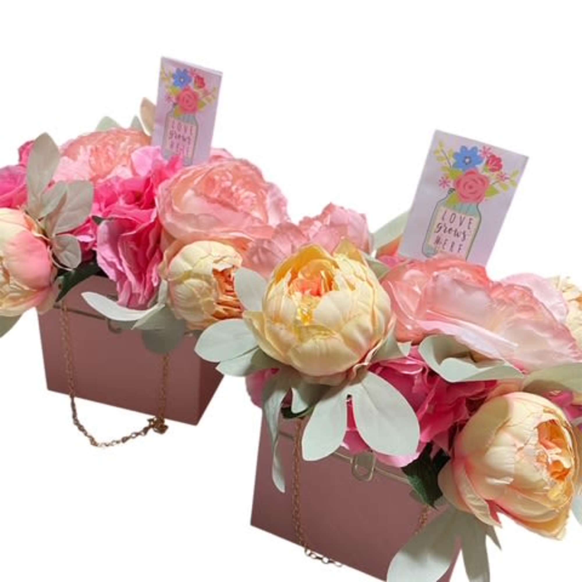 

Description: The &quot;Blooming Elegance Purse&quot; is a stunning silk flower arrangement delicately