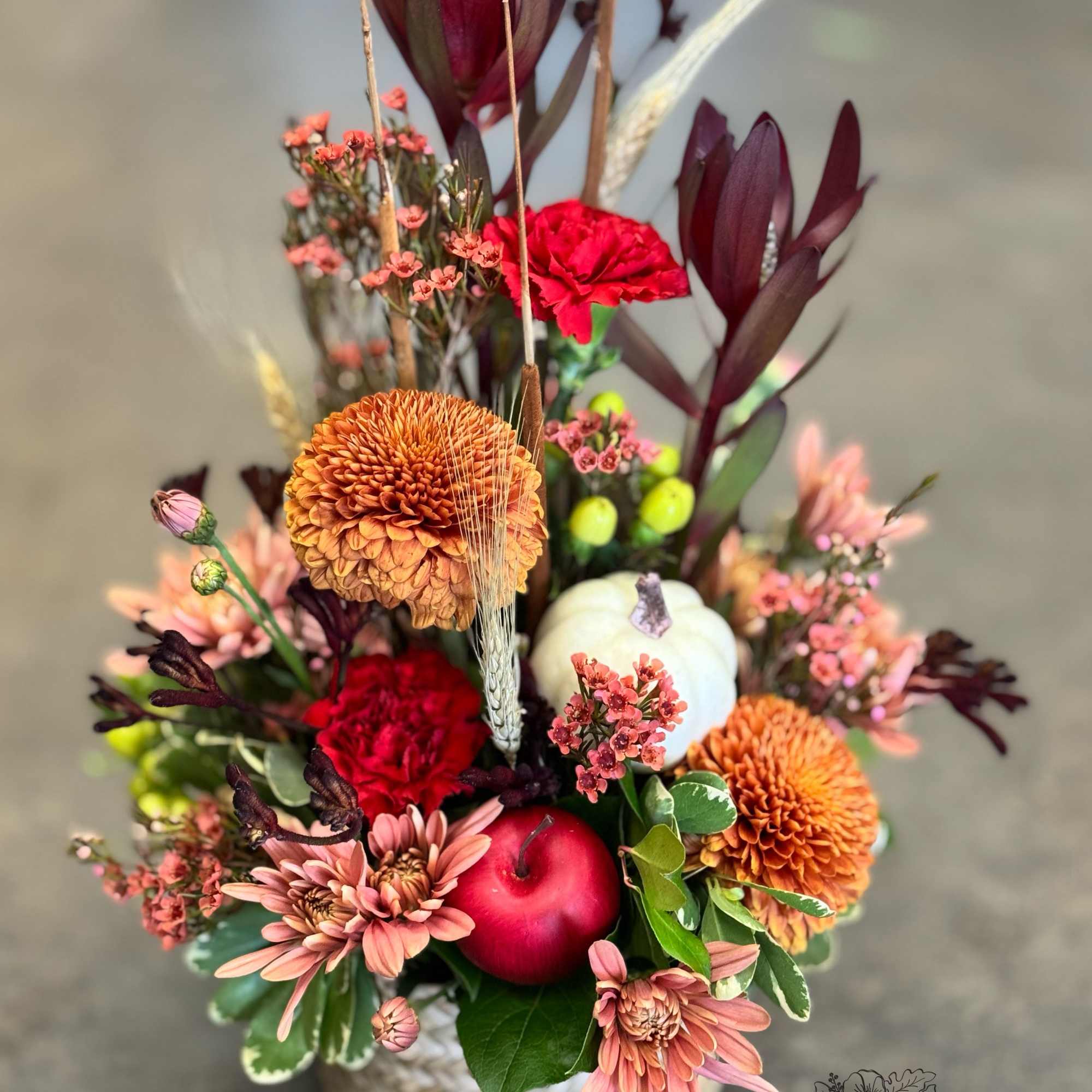 Handcrafted by Thompson’s Flower Shop, Rustic Autumn Gathering blends bronze mums, carnations Handcrafted by Thompson’s Flower Shop, Rustic Autumn Gathering blends bronze mums, carnations