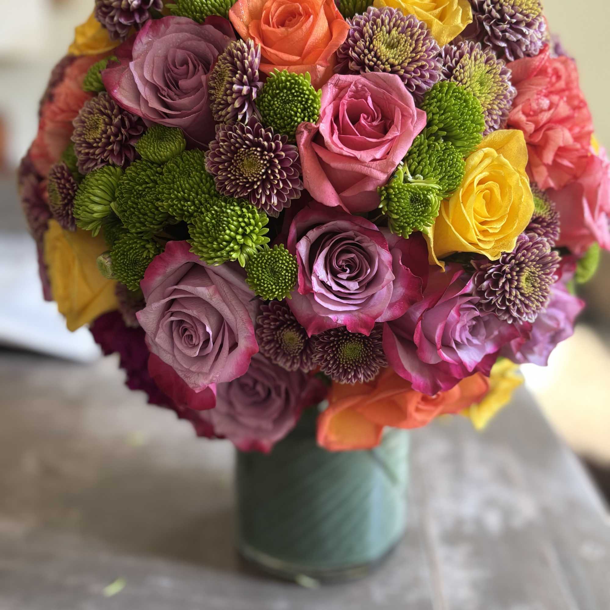Beautiful bright roses , green hydrangeas, carnations and spray roses along with
