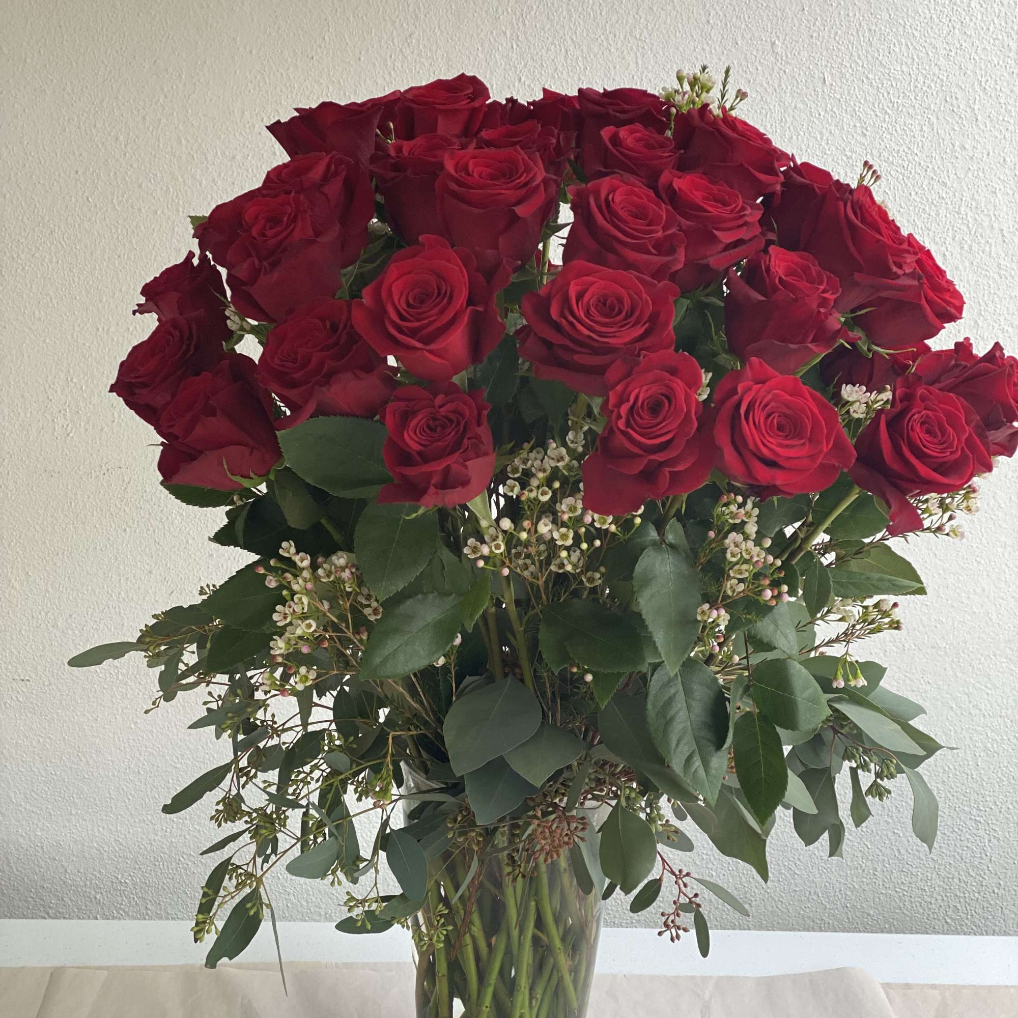 A charming arrangement of a dozen or two dozen high-quality, long-stemmed, fresh