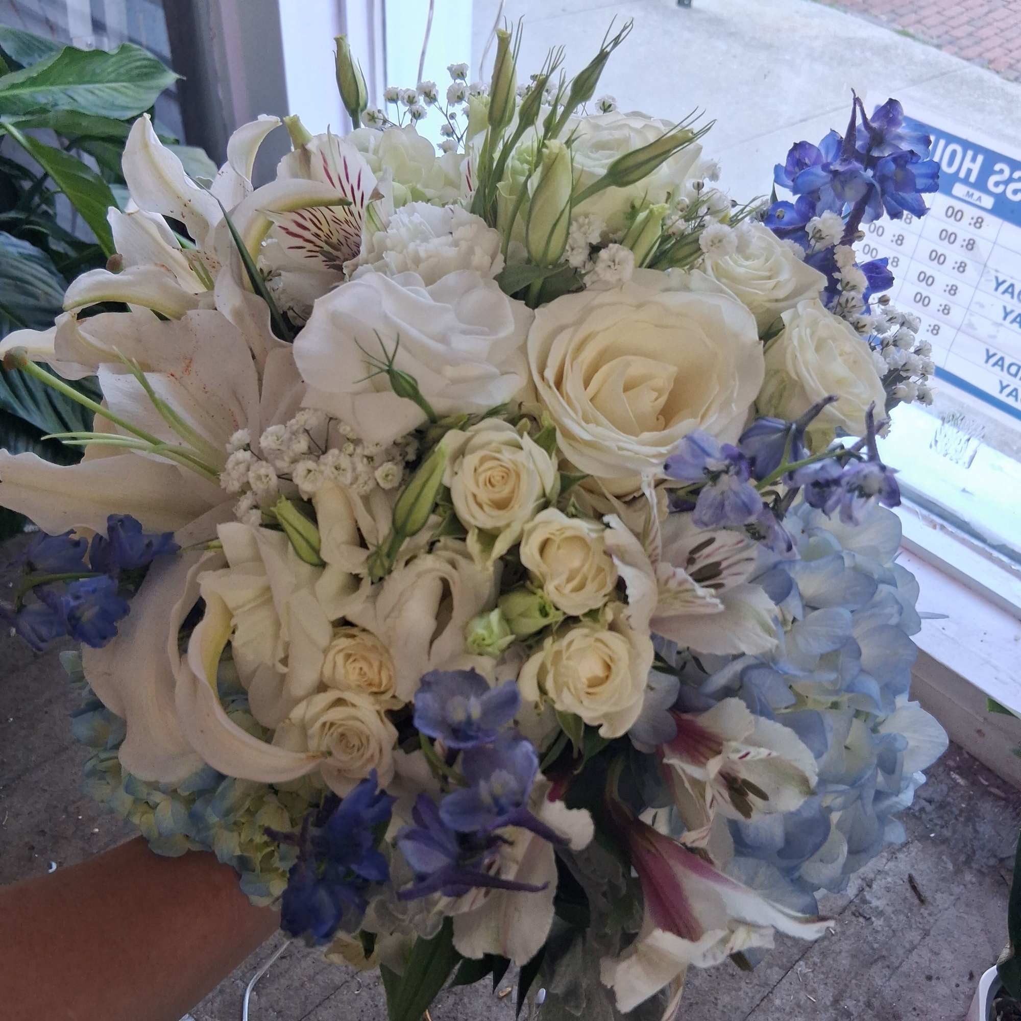 Magnificent white oriental lily, garden roses, white lisiantus, blue hydrangea and delphinium