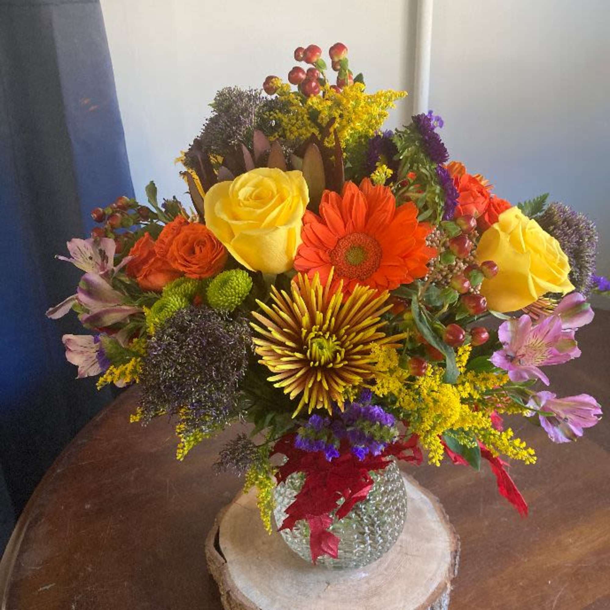 this medium sized arrangement is filled with fall flowers in a unique