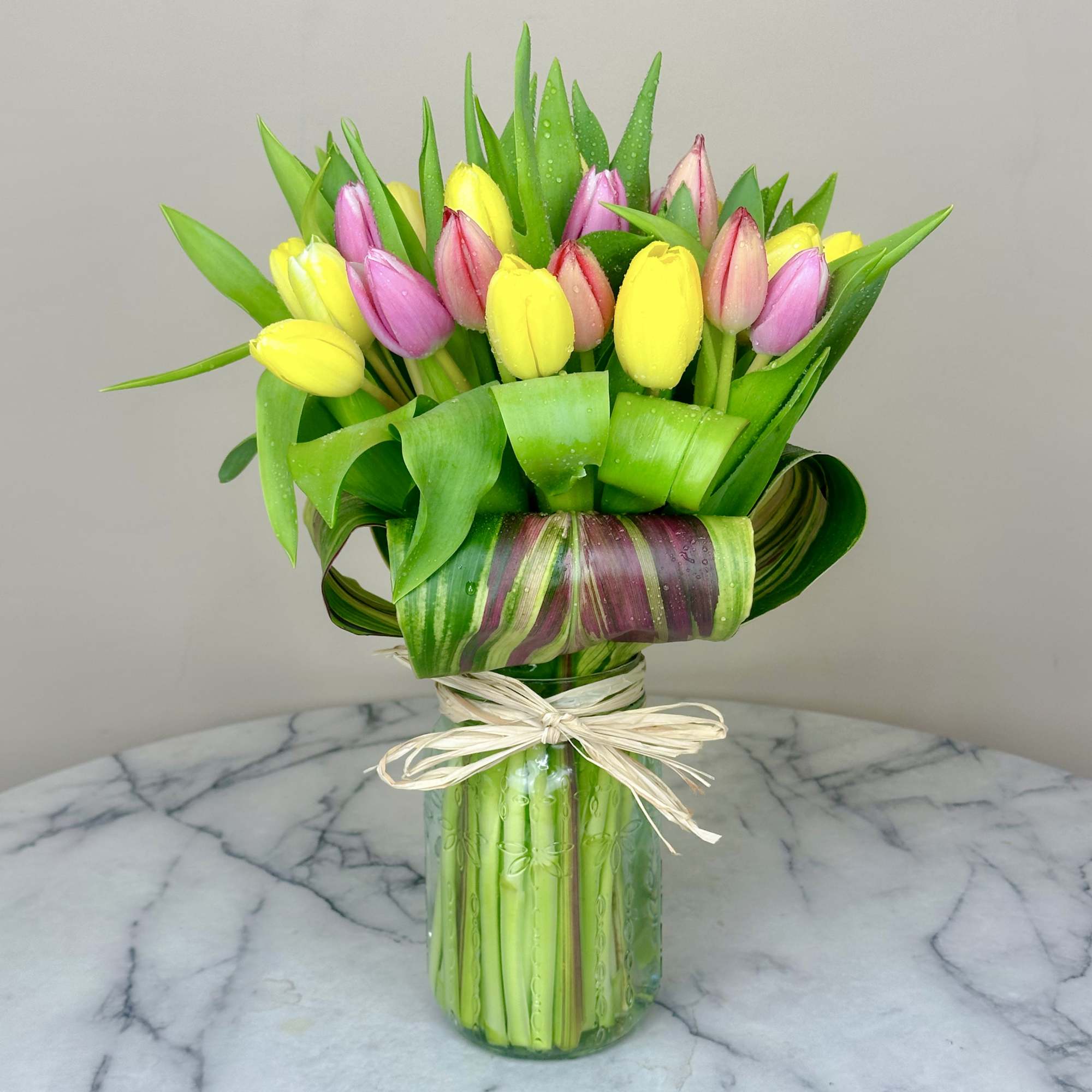 15 colorful tulips elegantly arranged in a keepsake mason jar vase. This