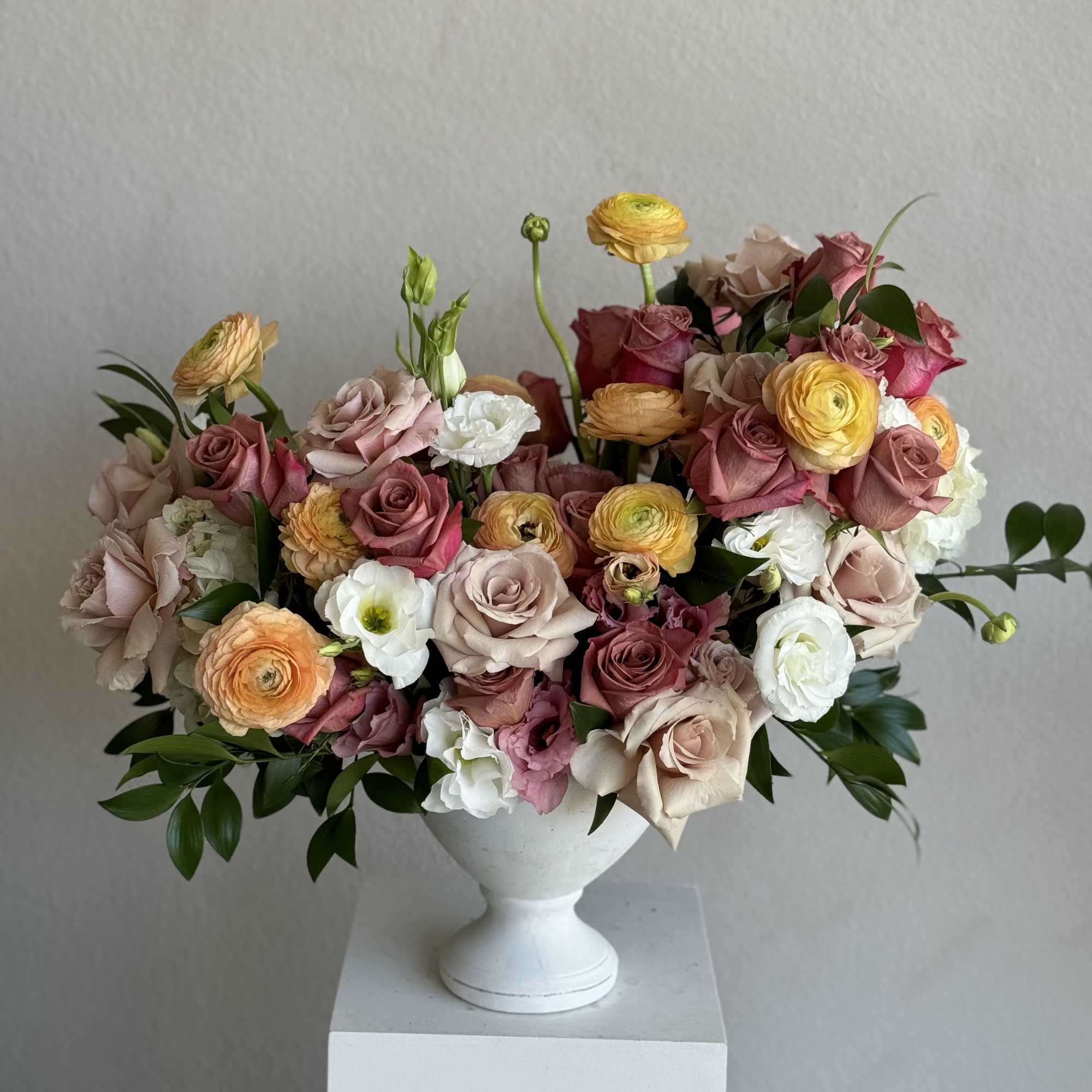 A charming arrangement of warm-toned roses that evoke the richness of a