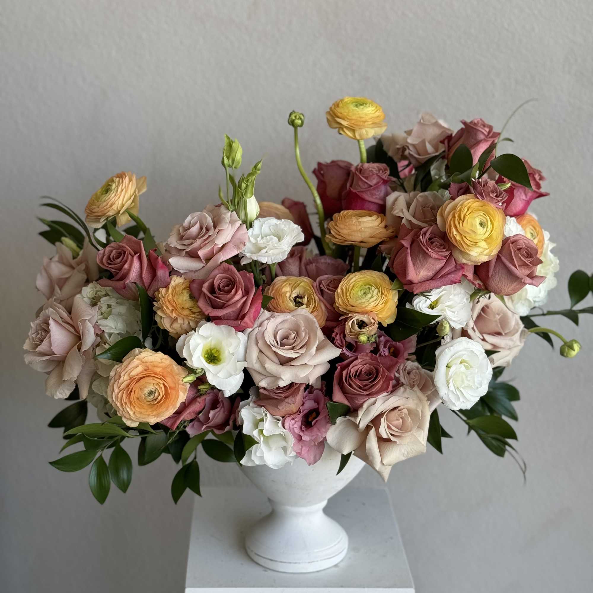 A charming arrangement of warm-toned roses that evoke the richness of a