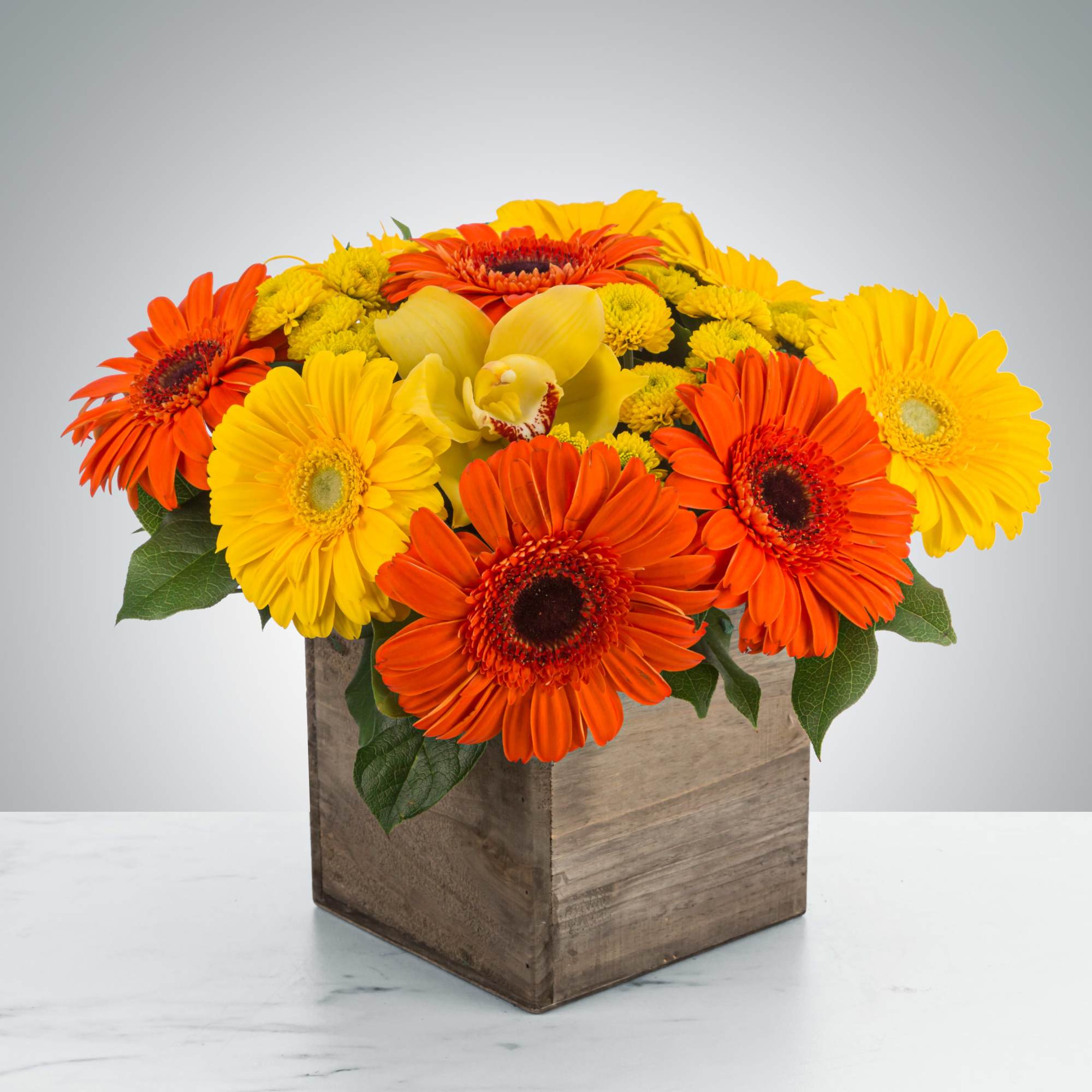 Everybody loves daisies! Send this cheerful wooden box featuring orange and yellow