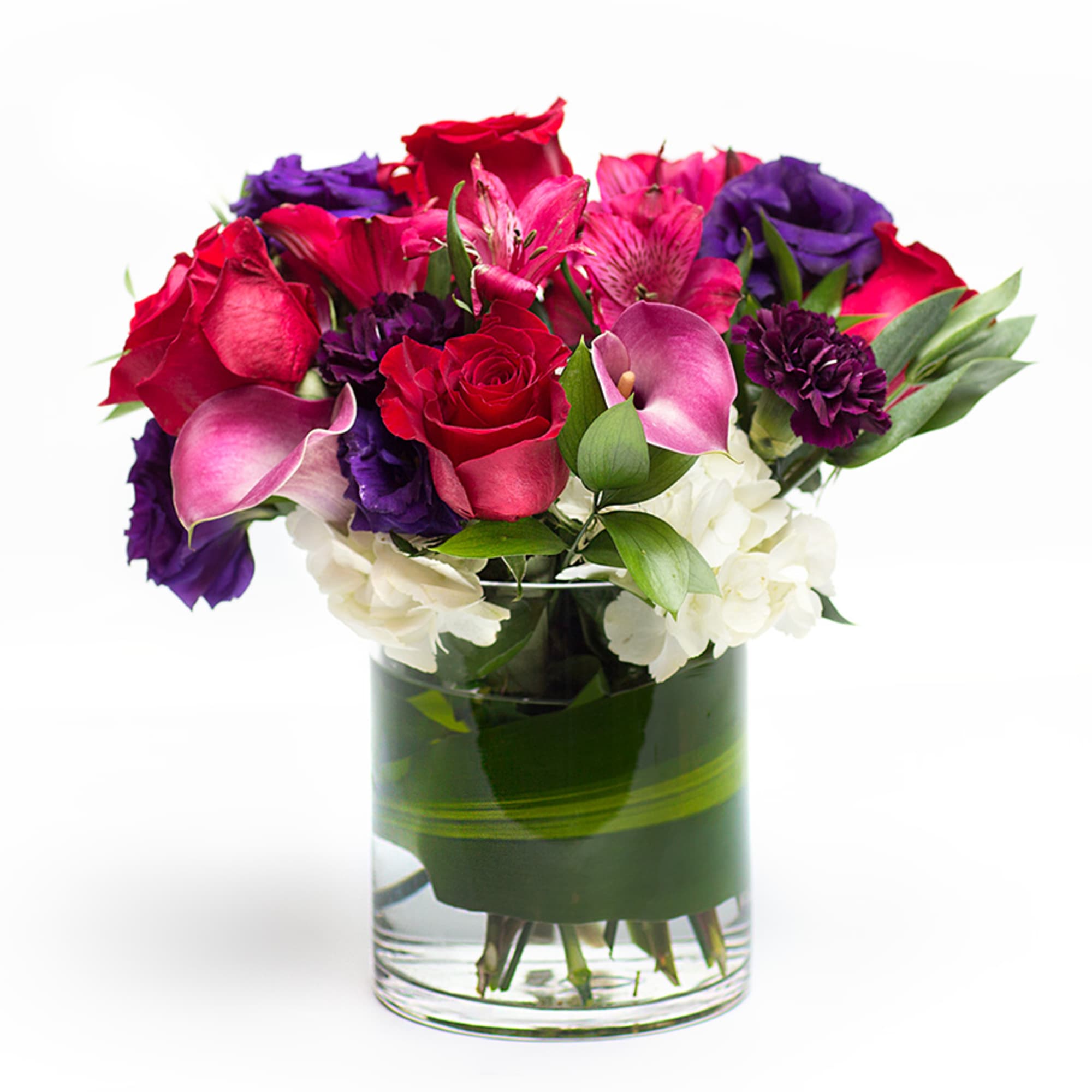 A rich display of our favorite calla lilies, roses with purple accents