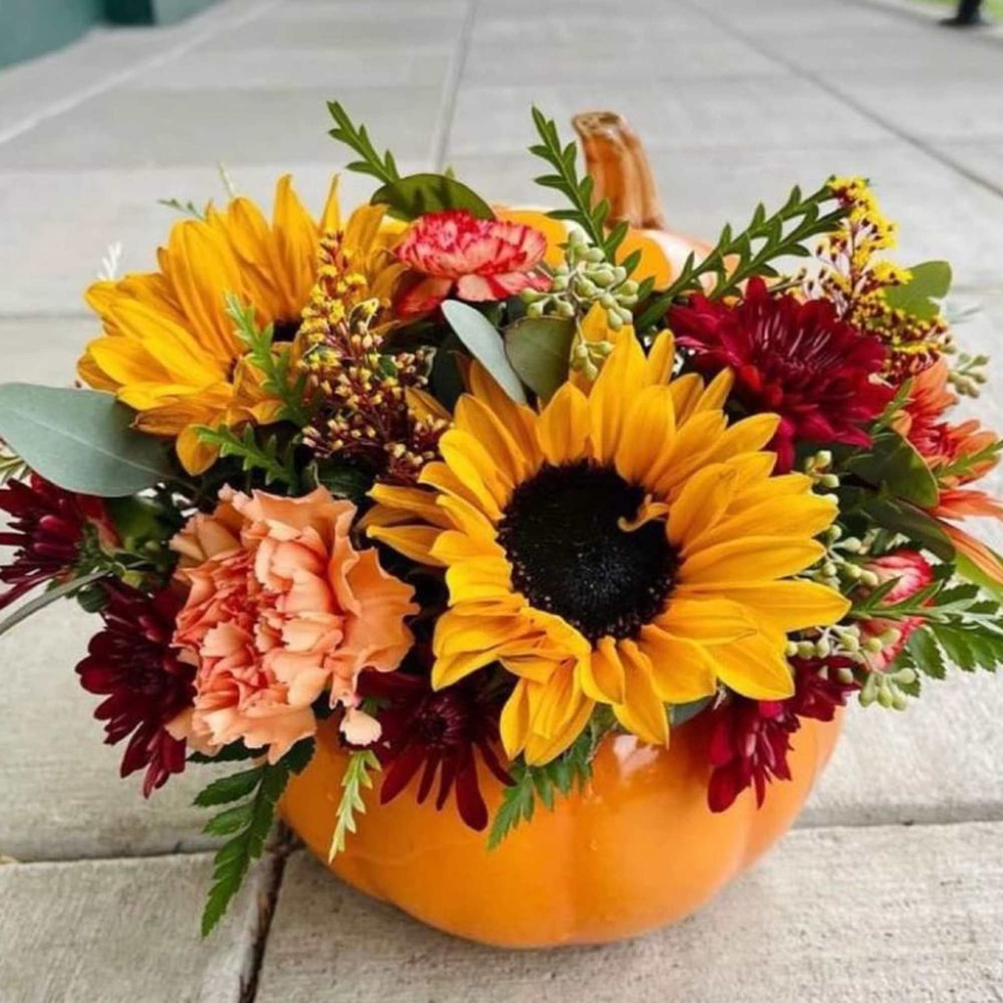 Celebrate the changing of the seasons with this ceramic orange pumpkin filled