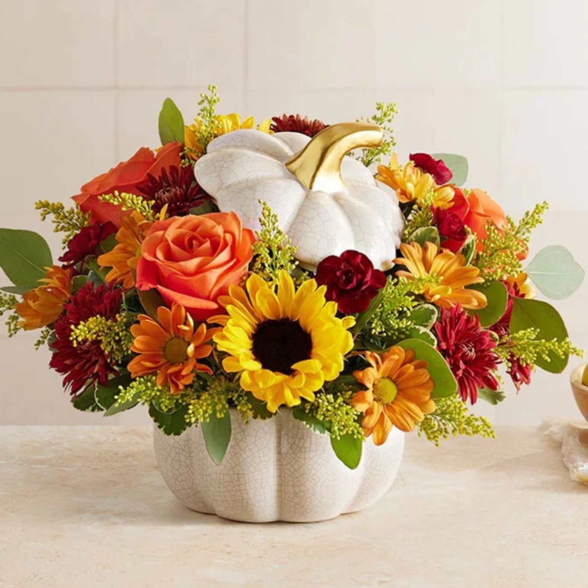 Celebrate the changing of the seasons with this ceramic white pumpkin filled