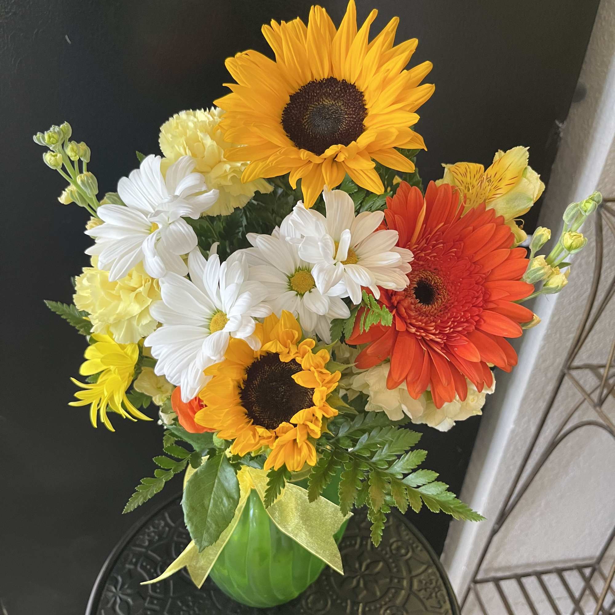 Fresh flowers in green vase 
