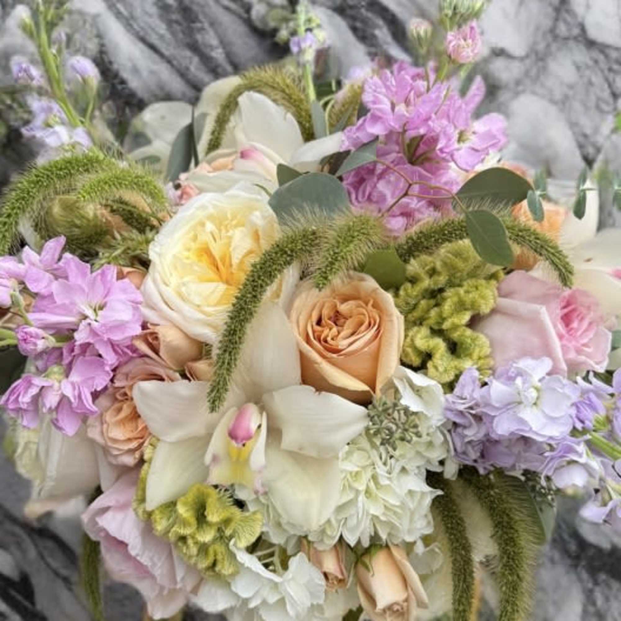 A soft and romantic arrangement featuring lush cream hydrangeas, delicate peach and