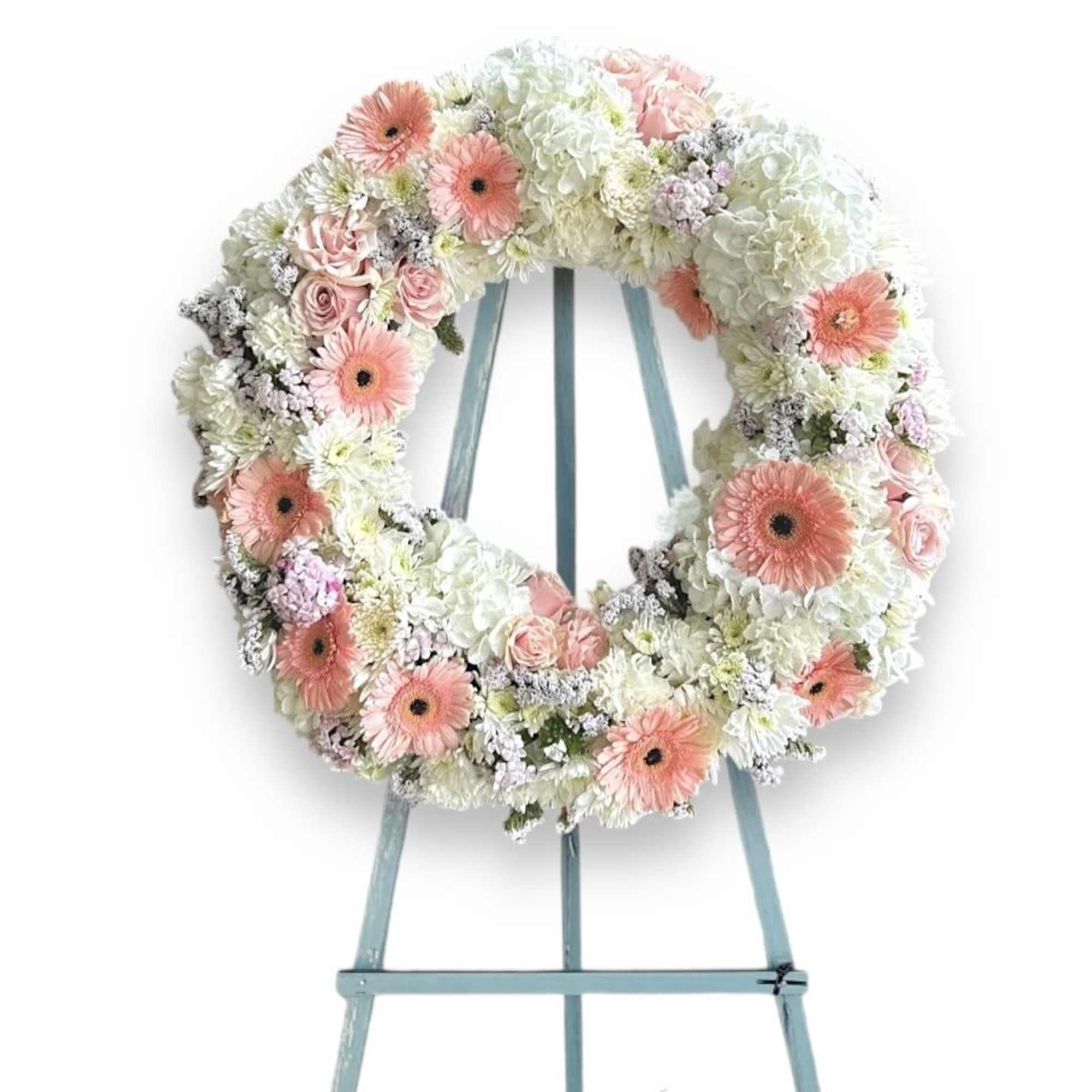 This Funeral Wreath contains:
White Hydrangea
Pink Gerbera Daisy
White Carnation
Pink Statice Pink Rose
Pink Sweet
