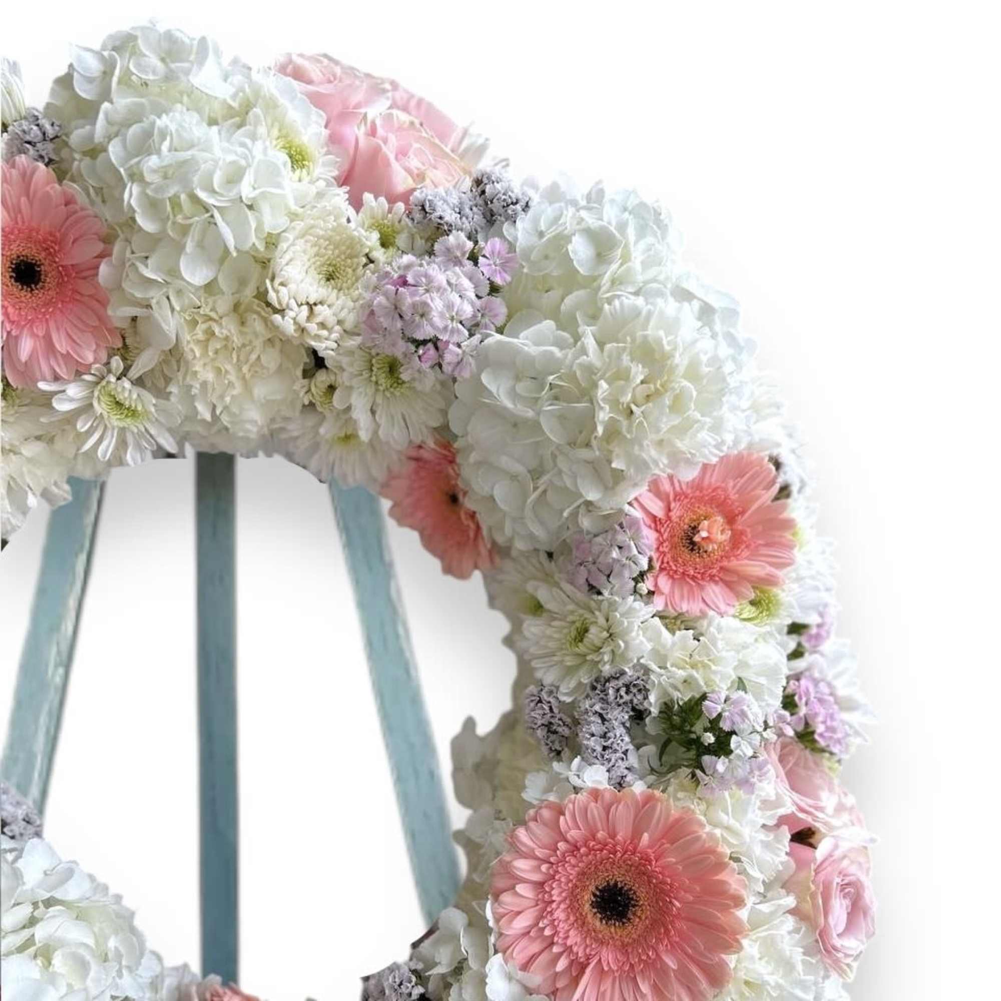This Funeral Wreath contains:
White Hydrangea
Pink Gerbera Daisy
White Carnation
Pink Statice Pink Rose
Pink Sweet