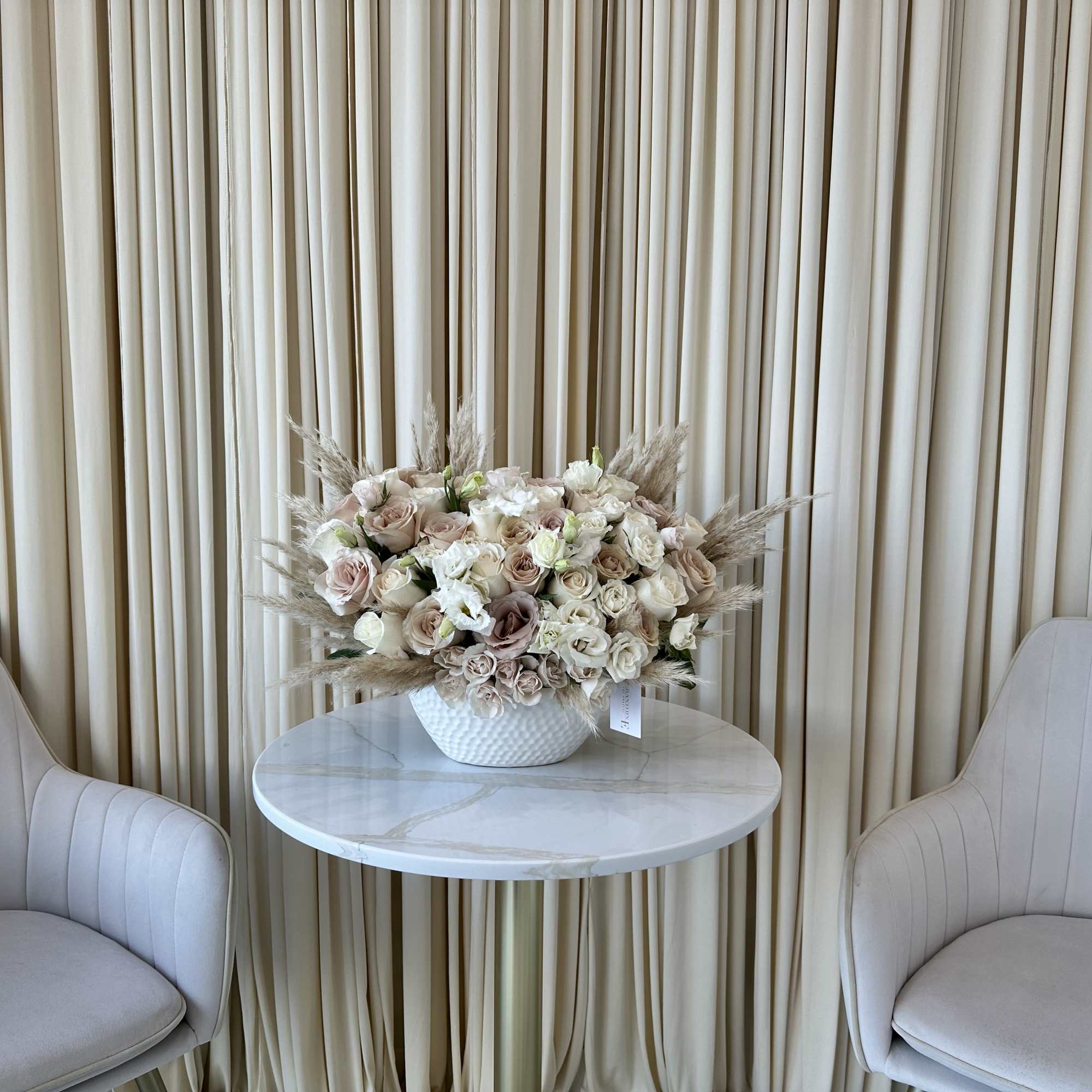 Elevate any space with timeless elegance. Our Elegant Whisper arrangement features a