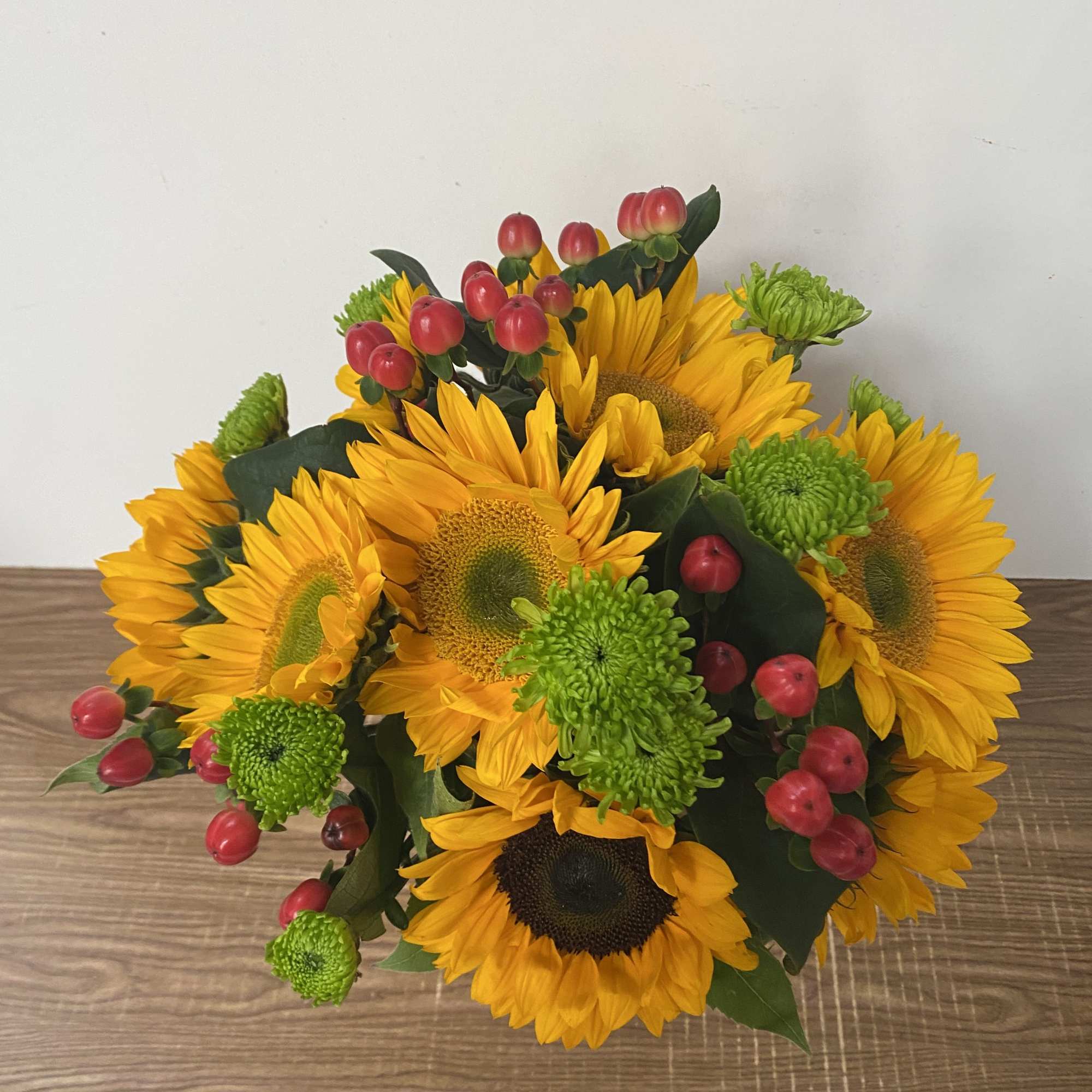 Bright, cheerful, and full of sunshine, this arrangement features seven radiant sunflowers