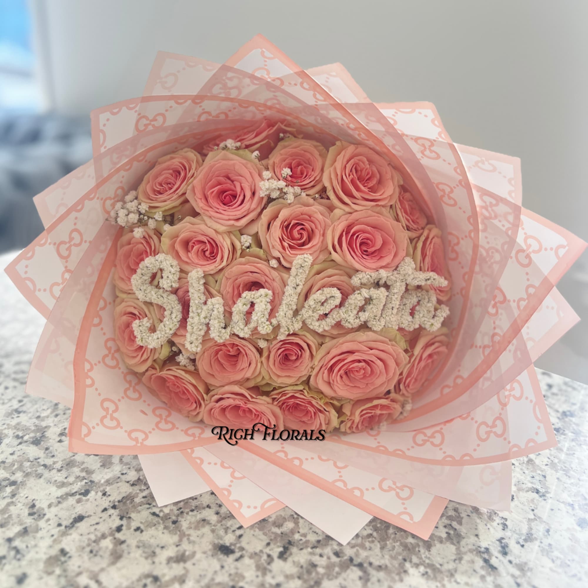 Standard: 25 roses, gucci floral wrap, light baby&#039;s breath
Premium: Baby&#039;s Breath Name