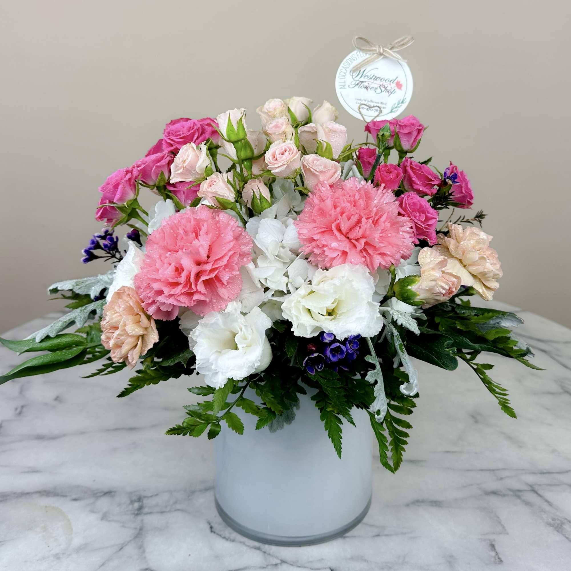 This angelic arrangement is as cute as it is pretty. Featuring the