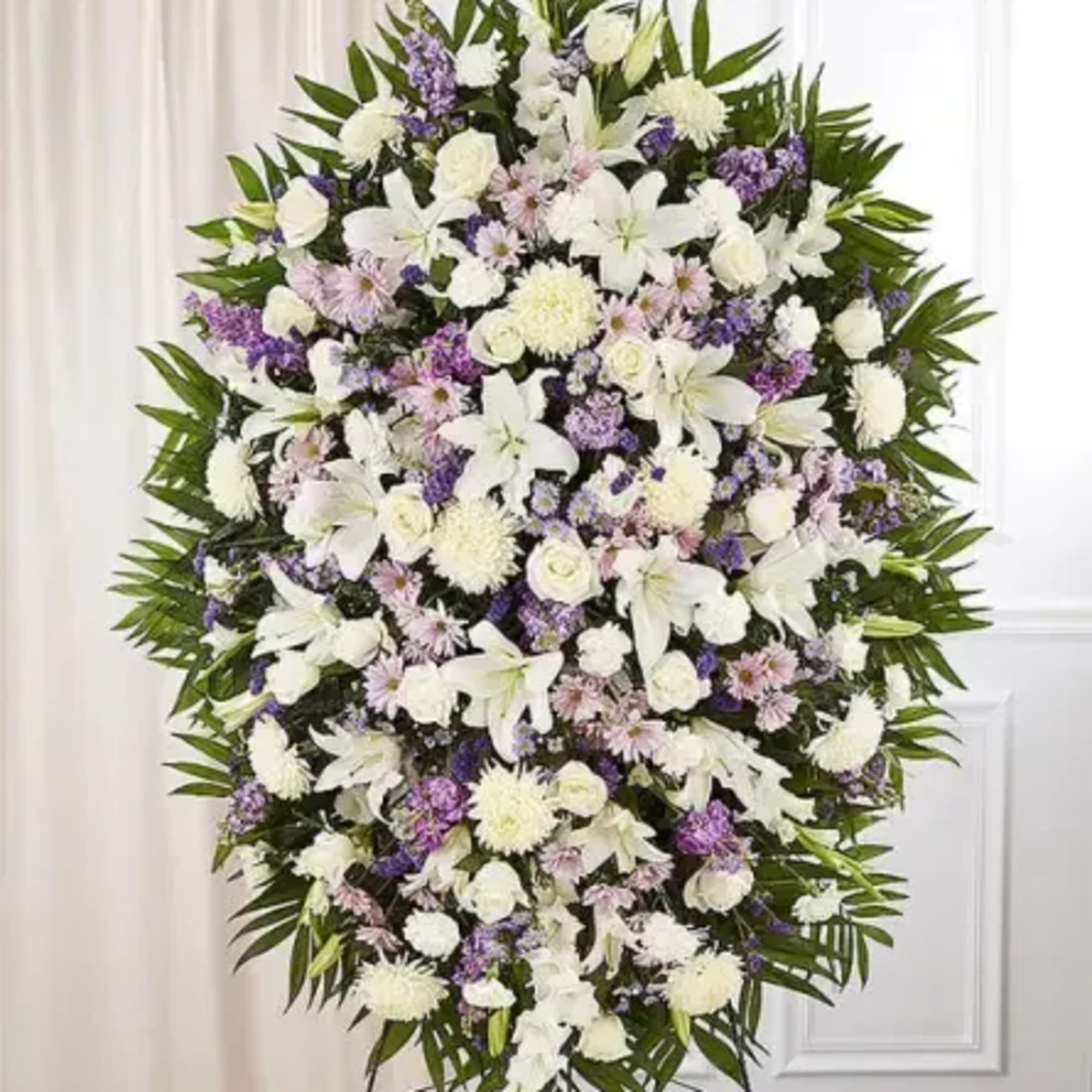 Elegant and soothing, this lavender and white standing spray is a heartfelt